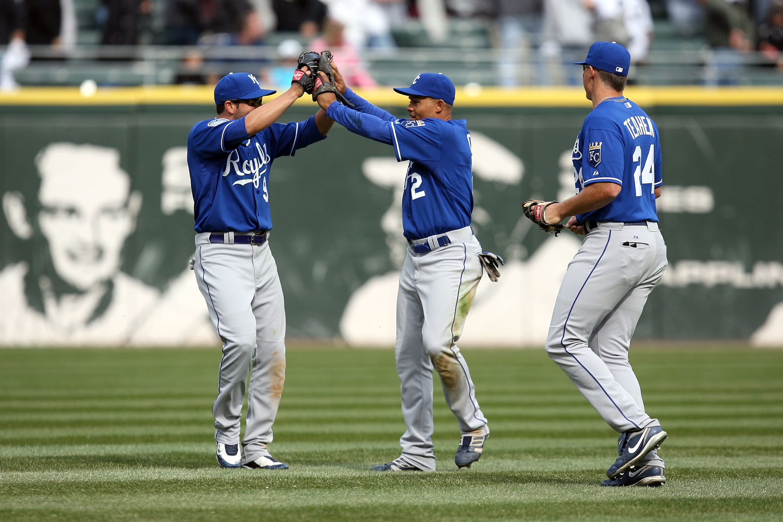 CHICAGO - APRIL 09:  (L-R) David DeJesus #9, Coco Crisp #2 and Mark Teahen #24 of the Kansas City Roayls celebrate after their 2-1 win against the Chicago White Sox at U.S. Cellular Field on April 9, 2009 in Chicago, Illinois.  (Photo by Jonathan Daniel/G