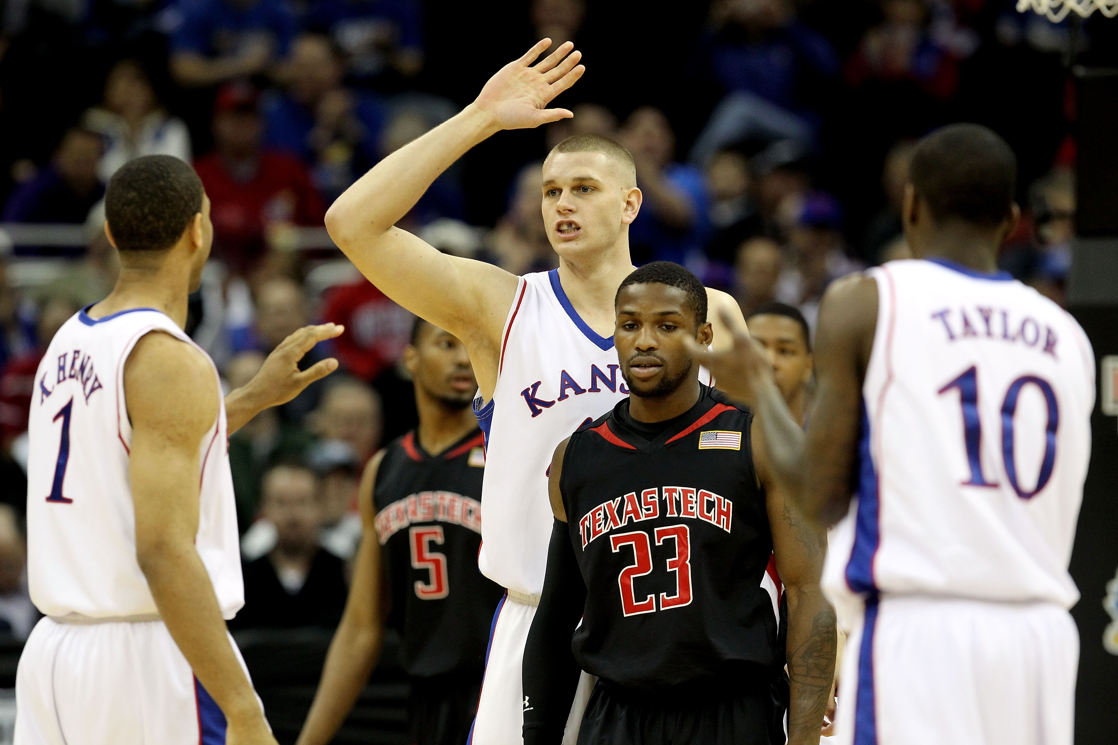 KANSAS CITY, MO - MARCH 11:  Cole Aldrich #45 of the Kansas Jayhawks reacts after getting fouled as he gives a high five to teammate Xavier Henry #1 as Nick Okorie #23 of the Texas Tech Red Raiders looks on in the first half during the quarterfinals of th