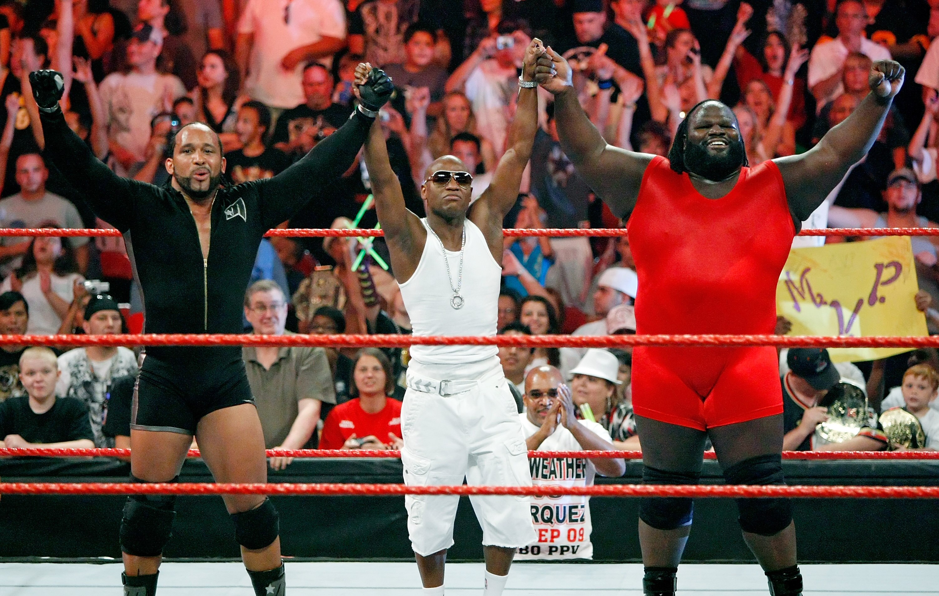 LAS VEGAS - AUGUST 24:  (L-R) Wrestler MVP, boxer Floyd Mayweather Jr. and wrestler Mark Henry celebrate at the end of a tag team match during the WWE Monday Night Raw show at the Thomas & Mack Center August 24, 2009 in Las Vegas, Nevada. Mayweather was a