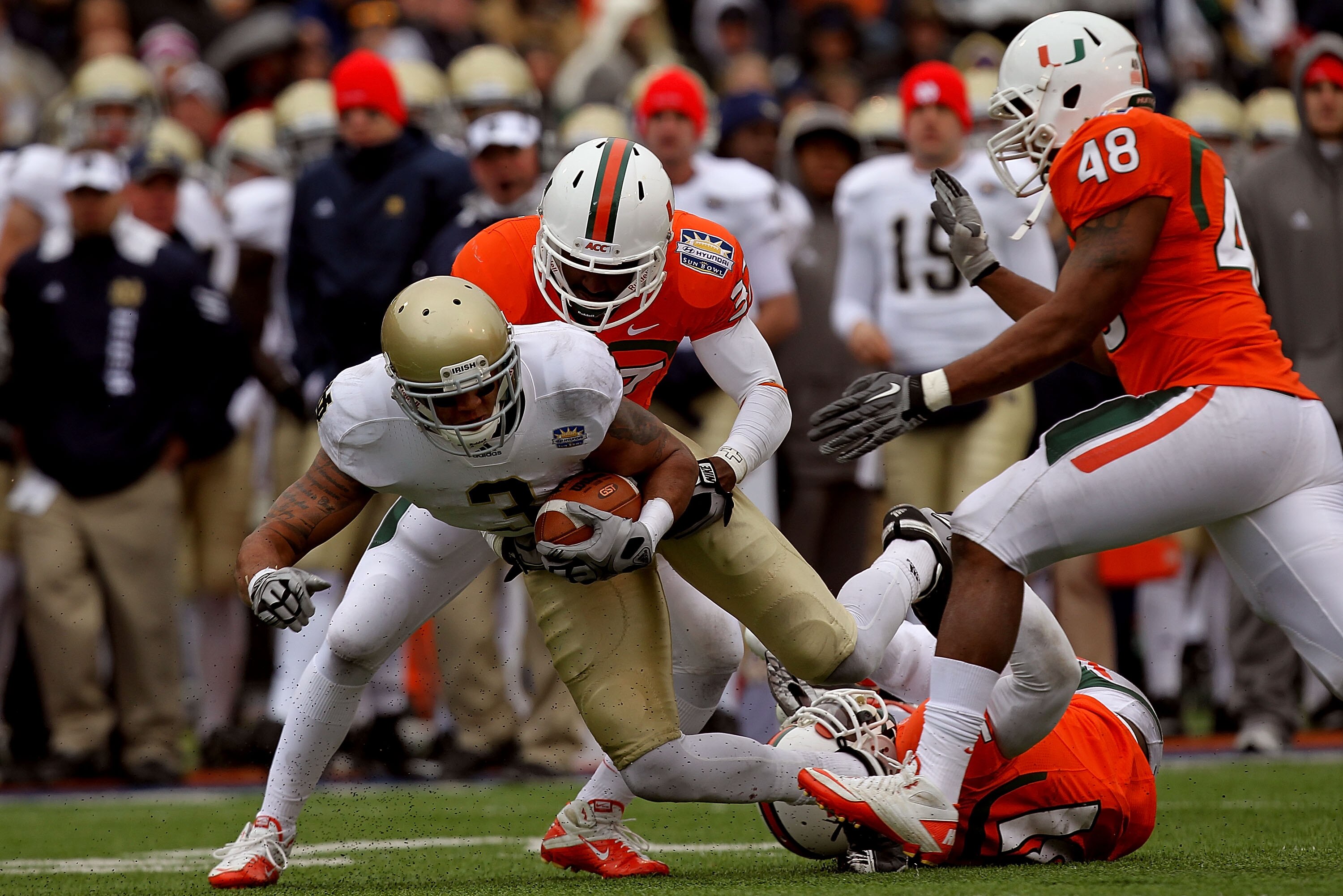 EL PASO, TX - DECEMBER 30:  Wide receiver Michael Floyd #3 of the Notre Dame Fighting Irish runs the ball past Jared Campbell #37, Sean Spence #31 and Andrew Smith #48 of the Miami Hurricanes at Sun Bowl on December 30, 2010 in El Paso, Texas.  (Photo by