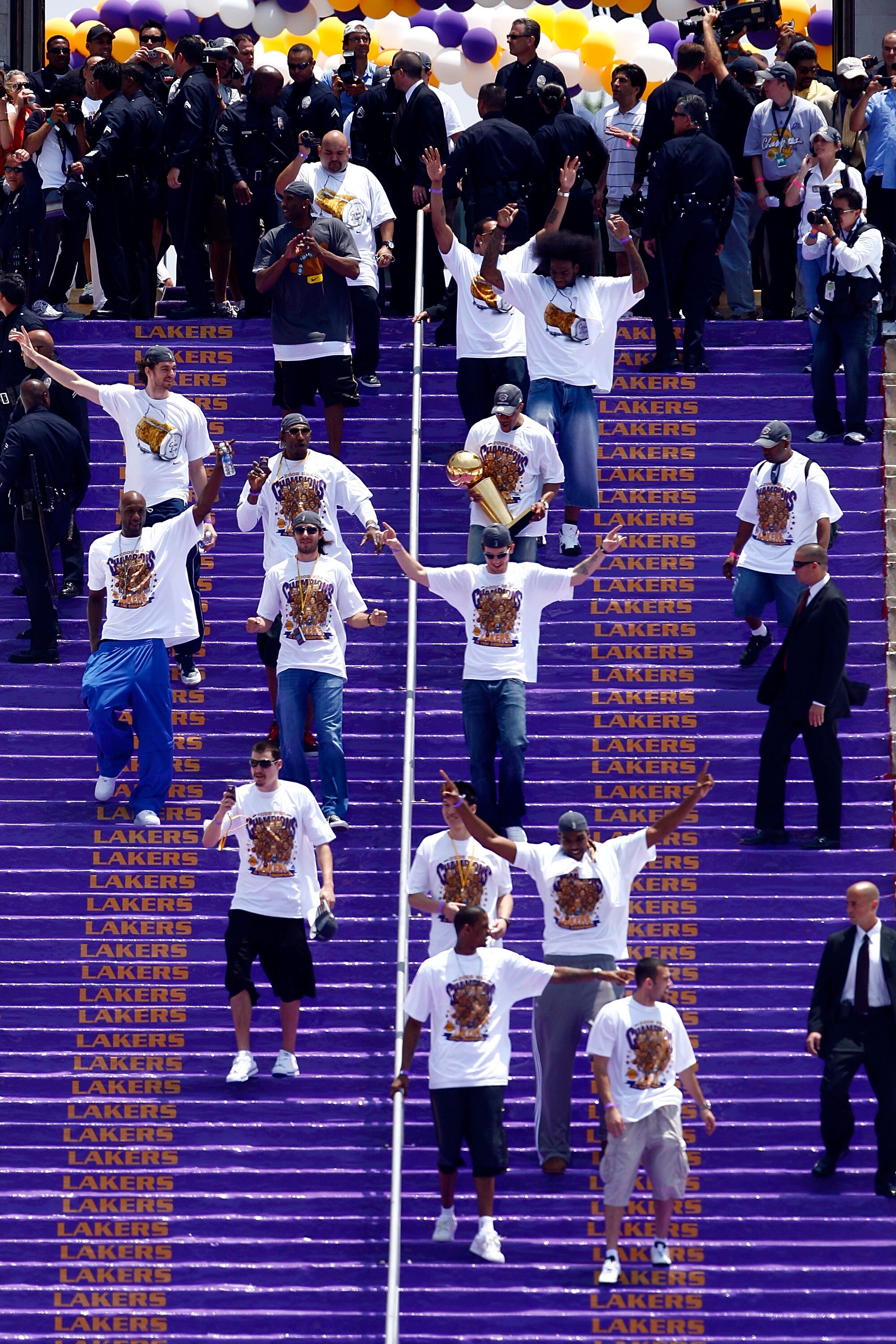 LOS ANGELES, CA - JUNE 17:  (Top-Bottom, l-r) Josh Powell, Pau Gasol, DJ Mbenga, Derek Fisher, Lamar Odom, Sasha Vujacic, Luke Walton, Adam Morrison, Sun Yue, Andrew Bynum, Trevor Ariza and Jordan Farmar of the Los Angeles Lakers walk down the steps durin