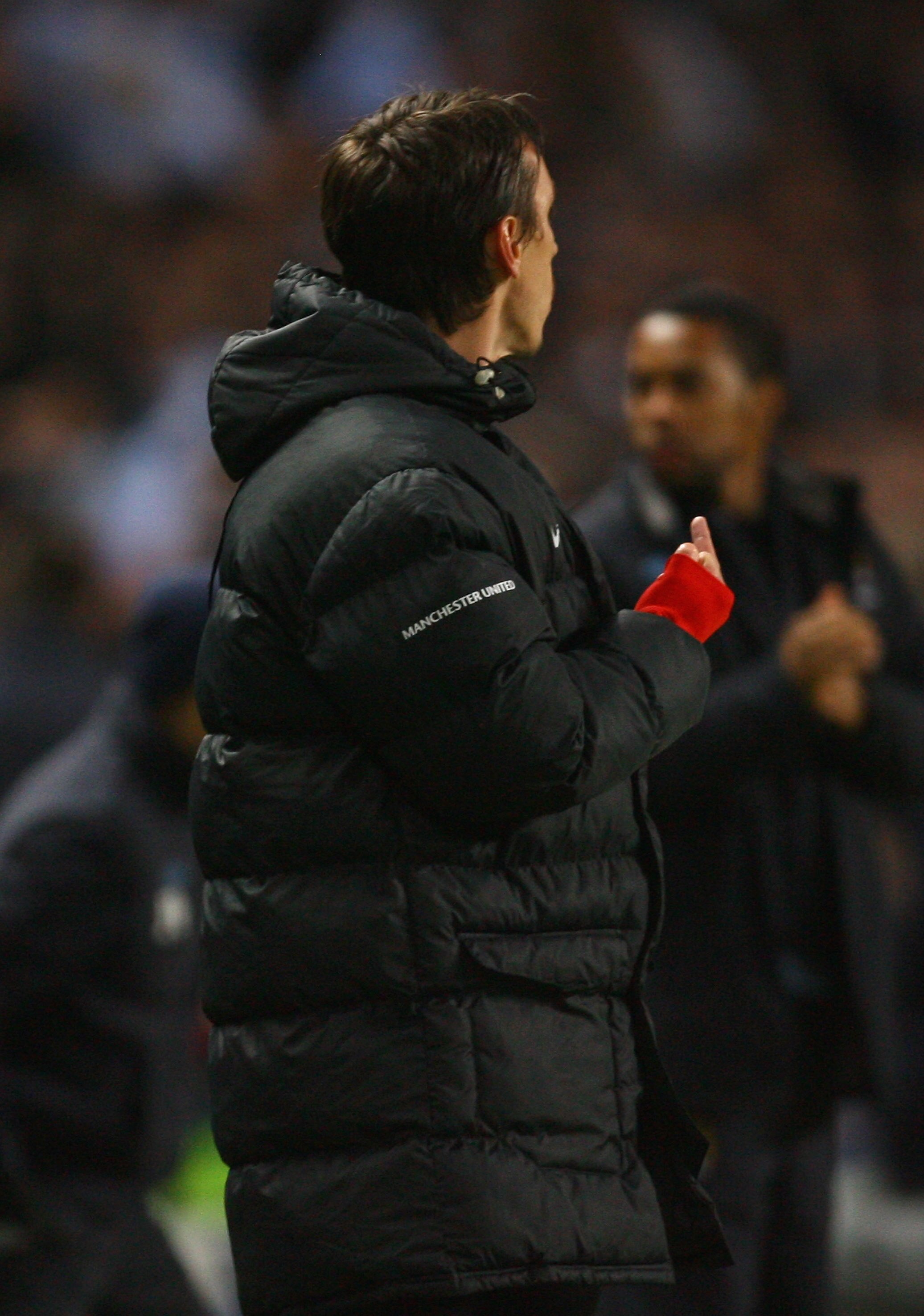 MANCHESTER, ENGLAND - JANUARY 19:  Gary Neville of Manchester United gestures after Carlos Tevez of Manchester City scored his team's first goal during the Carling Cup Semi Final match between Manchester City and Manchester United at the City of Mancheste