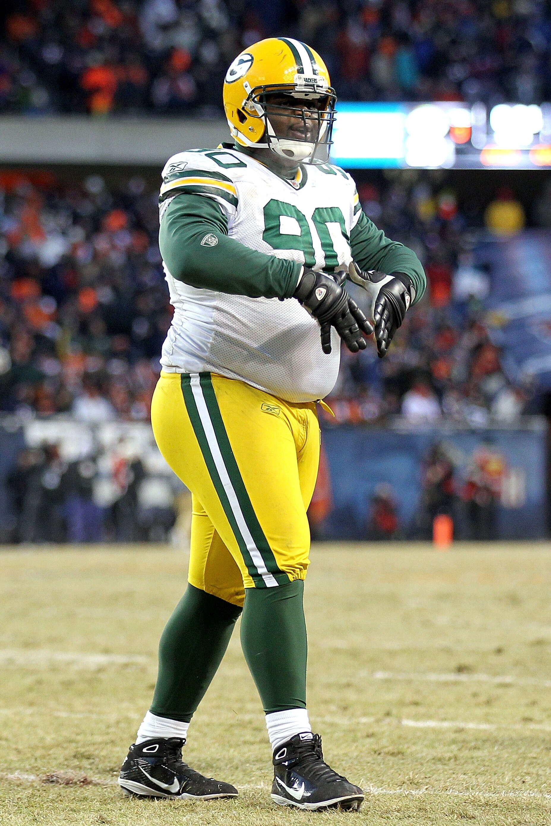 CHICAGO, IL - JANUARY 23:  B.J. Raji #90 of the Green Bay Packers reacts after scoring on a 18-yard interception return for a touchdown in the fourth quarter against the Chicago Bears in the NFC Championship Game at Soldier Field on January 23, 2011 in Ch