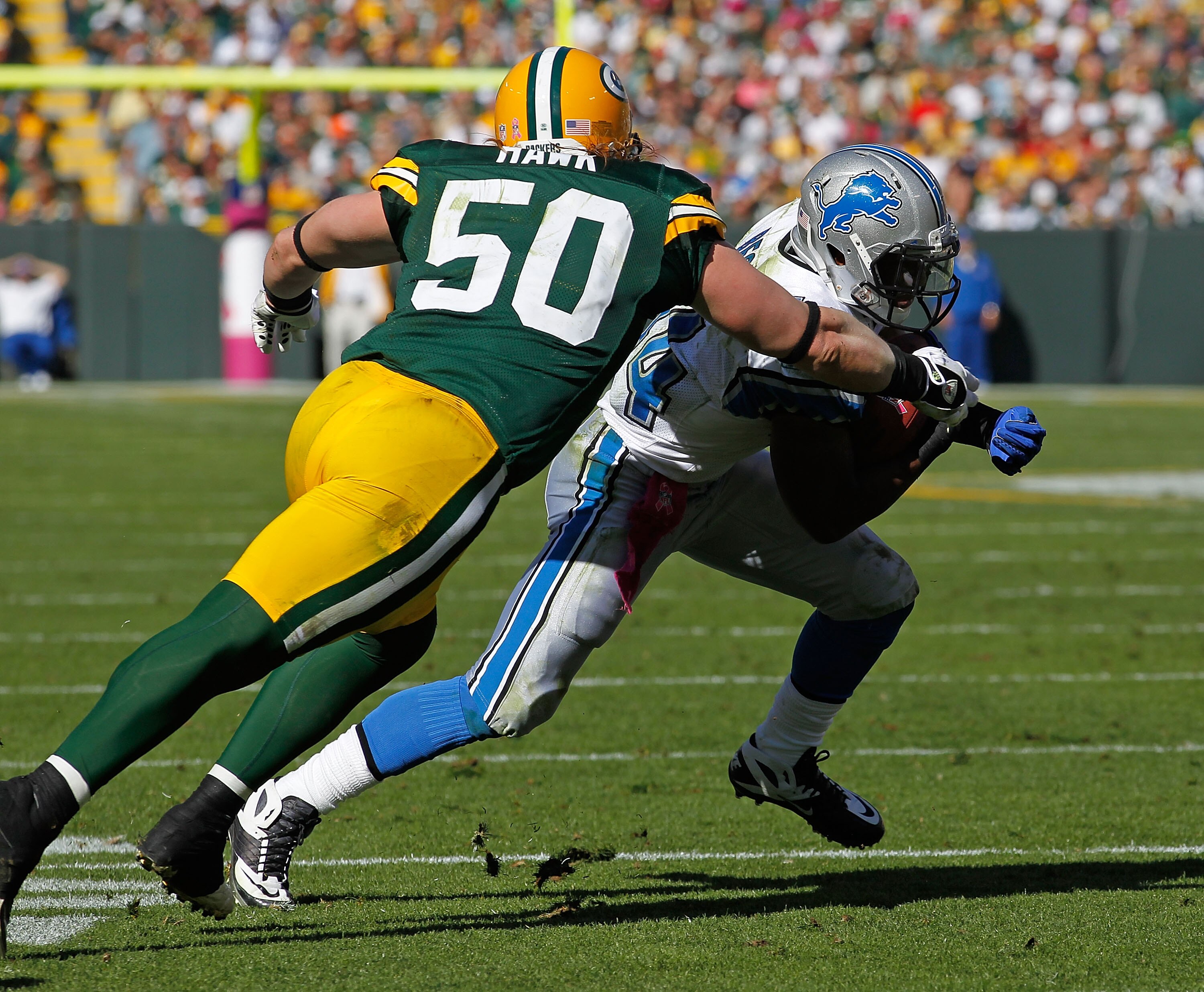 GREEN BAY, WI - OCTOBER 03: Jahvid Best #44 of the Detroit Lions runs as A.J. Hawk #50 the Green Bay Packers moves for the tackle at Lambeau Field on October 3, 2010 in Green Bay, Wisconsin. The Packers defeated the Lions 28-26. (Photo by Jonathan Daniel/