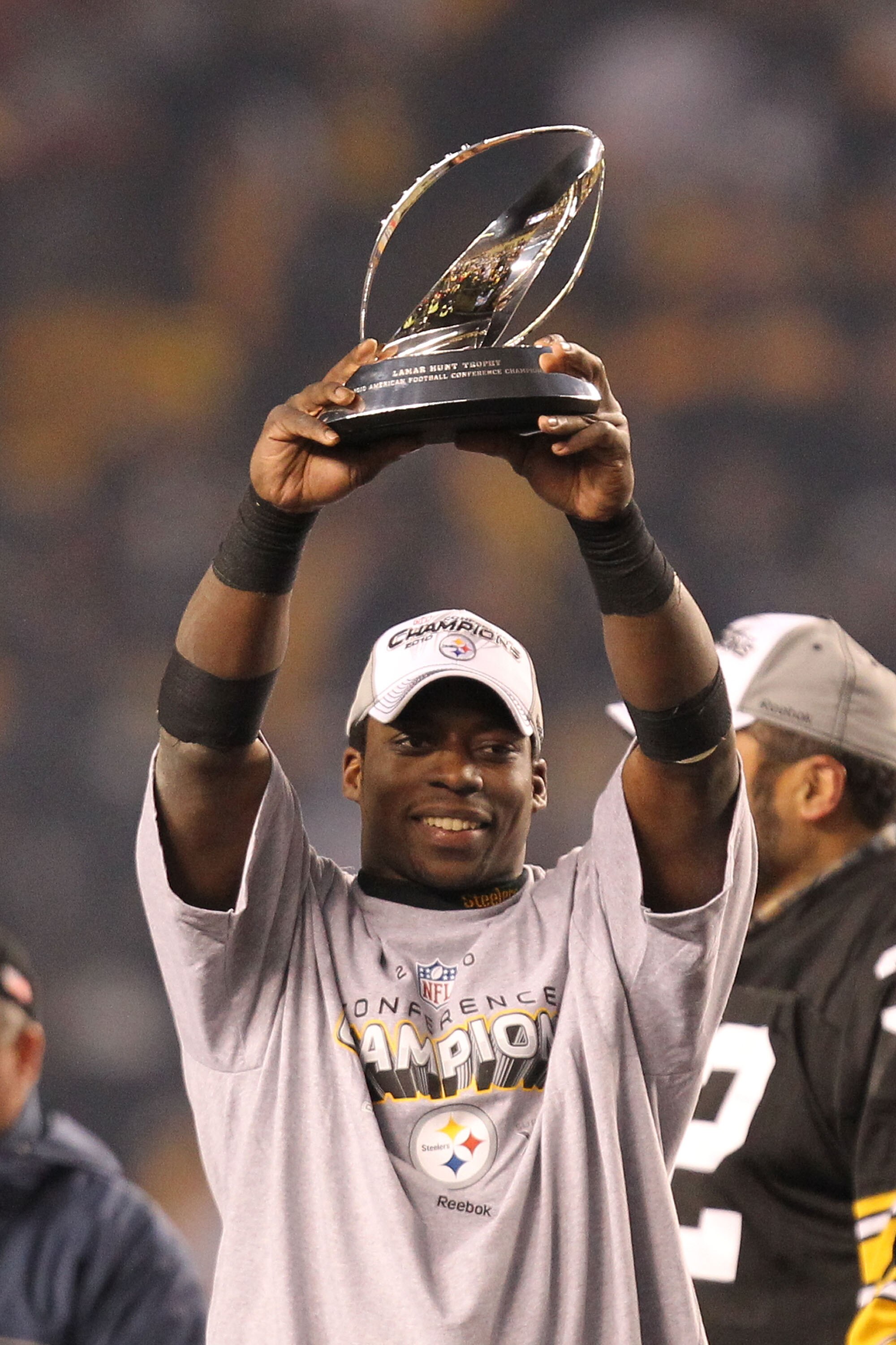 PITTSBURGH, PA - JANUARY 23:  Rashard Mendenhall #34 of the Pittsburgh Steelers holds up the Lamar Hunt trophy after the Steelers defeated the New York Jets 24 to 19 in the 2011 AFC Championship game at Heinz Field on January 23, 2011 in Pittsburgh, Penns