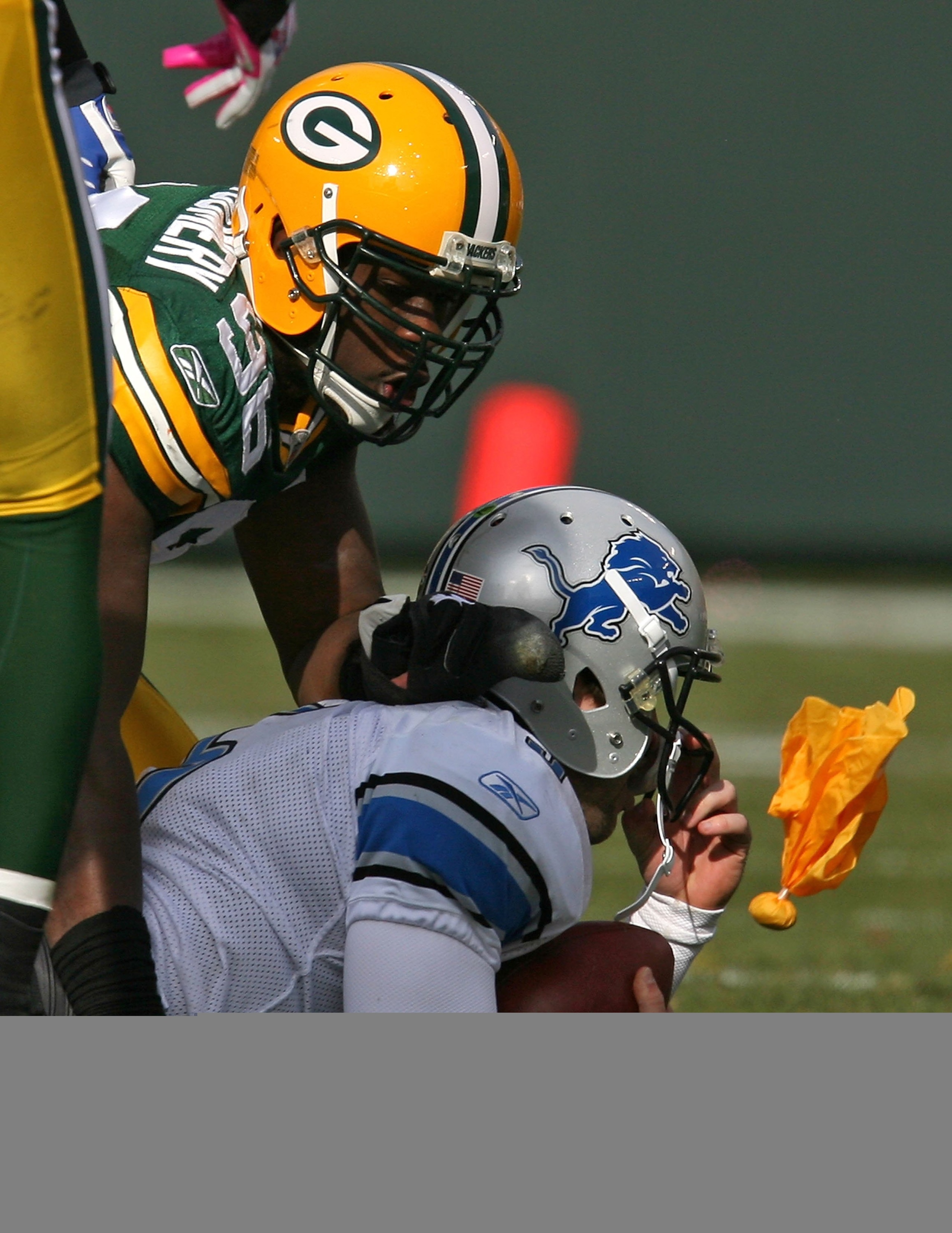 GREEN BAY, WI - OCTOBER 18: A penalty flag against Nick Barnett #56 of the Green Bay Packers flies past the face of Drew Stanton #5 of the Detroit Lions at Lambeau Field on October 18, 2009 in Green Bay, Wisconsin. The Packers defeated the Lions 26-0. (Ph