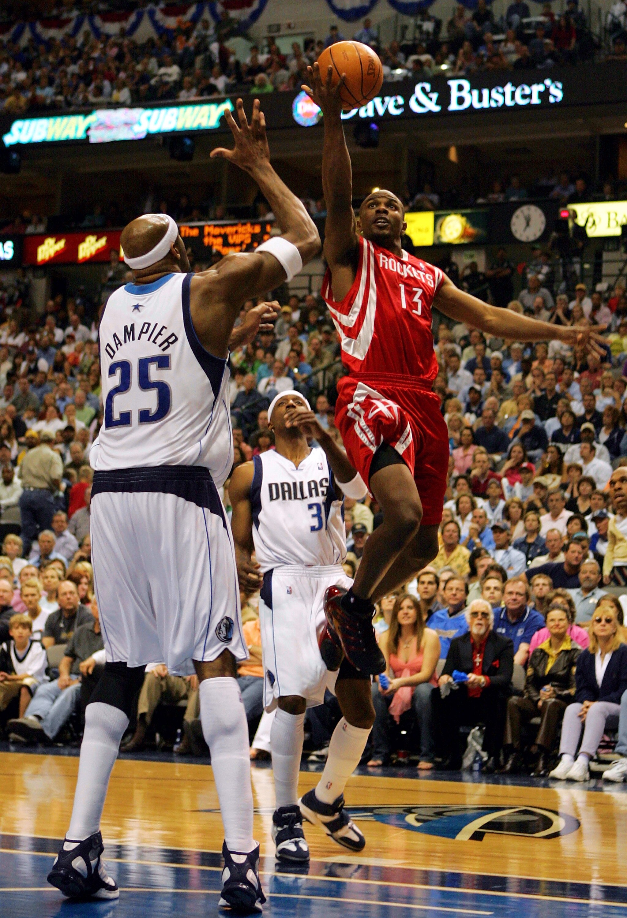 DALLAS - APRIL 23:  Guard Mike James #13 of the Houston Rockets drives the hoop against Erick Dampier #25 of the Dallas Mavericks in Game one of the Western Conference Quarterfinals during the 2005 NBA Playoffs on April 23, 2005 at the American Airlines C