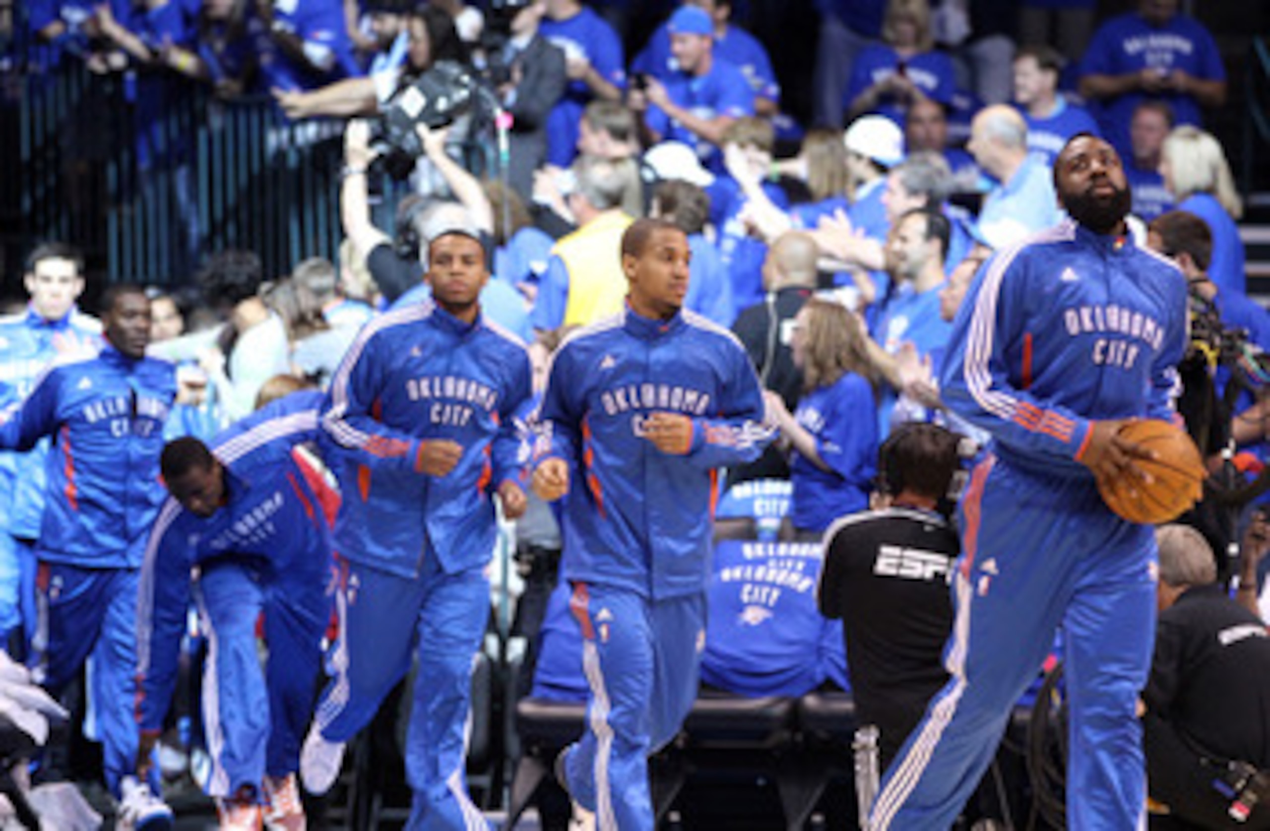 OKLAHOMA CITY, OK - MAY 23:  (R-L) James Harden #13, Eric Maynor #6 and Daequan Cook #14 run out of the tunnel before taking on the Dallas Mavericks in Game Four of the Western Conference Finals during the 2011 NBA Playoffs at Oklahoma City Arena on May 2