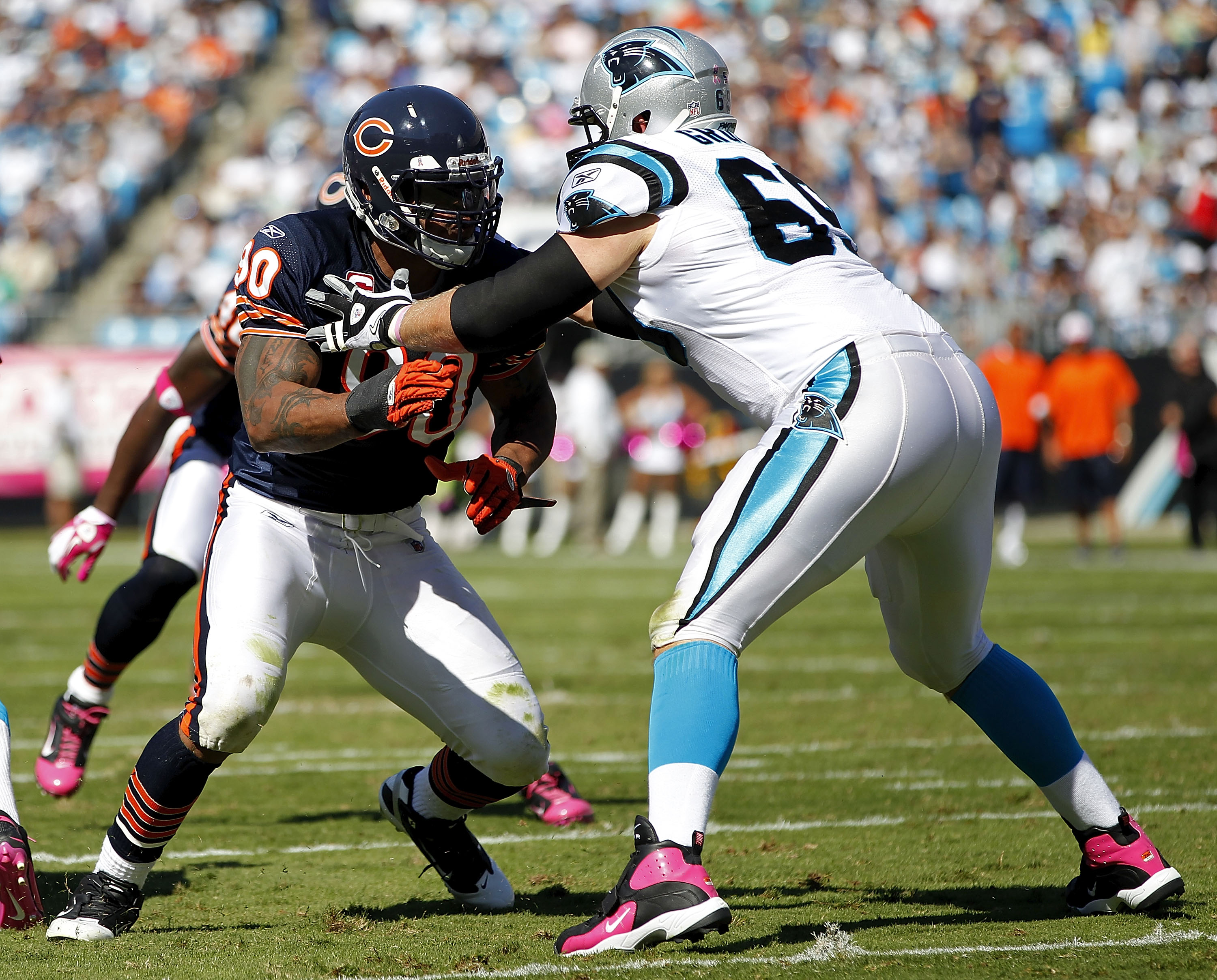 CHARLOTTE, NC - OCTOBER 10: Offensive tackle Jordan Gross #69 of the Carolina Panthers blocks defensive end Julius Peppers #90 of the Chicago Bears at Bank of America Stadium on October 10, 2010 in Charlotte, North Carolina. (Photo by Geoff Burke/Getty Im
