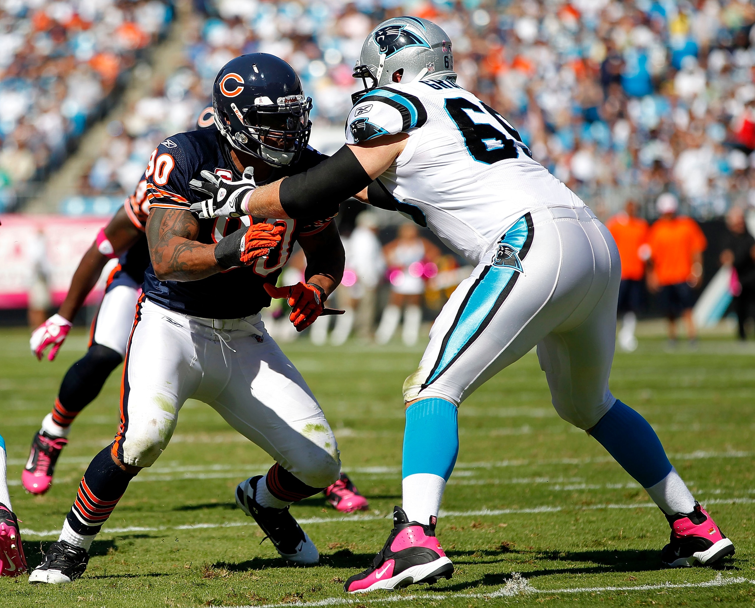 CHARLOTTE, NC - OCTOBER 10: Offensive tackle Jordan Gross #69 of the Carolina Panthers blocks defensive end Julius Peppers #90 of the Chicago Bears at Bank of America Stadium on October 10, 2010 in Charlotte, North Carolina. (Photo by Geoff Burke/Getty Im