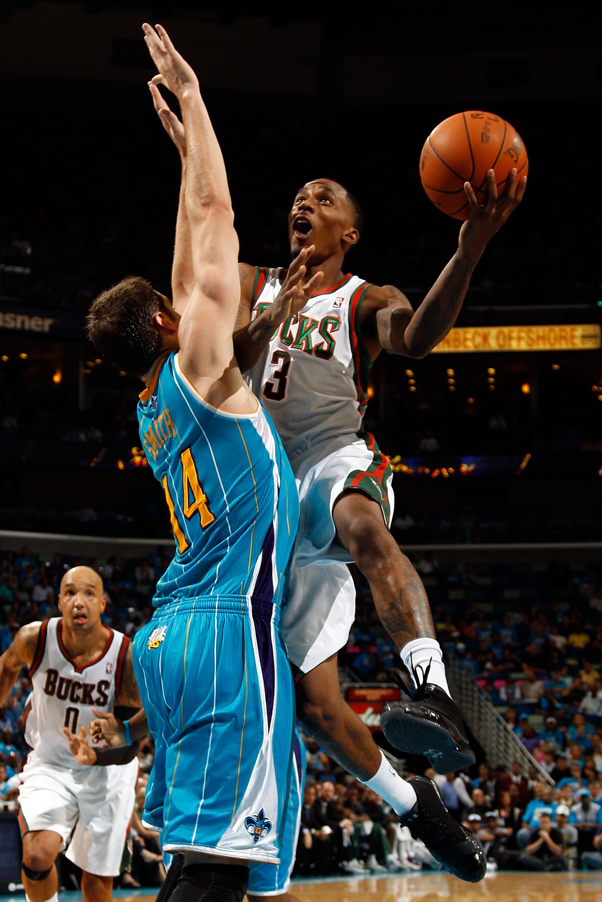 NEW ORLEANS - OCTOBER 27:  Brandon Jennings #3 of the Milwaukee Bucks shoots the ball over Jason Smith #14 of the New Orleans Hornets at the New Orleans Arena on October 27, 2010 in New Orleans, Louisiana.   The Hornets defeated the Bucks 95-91.   NOTE TO