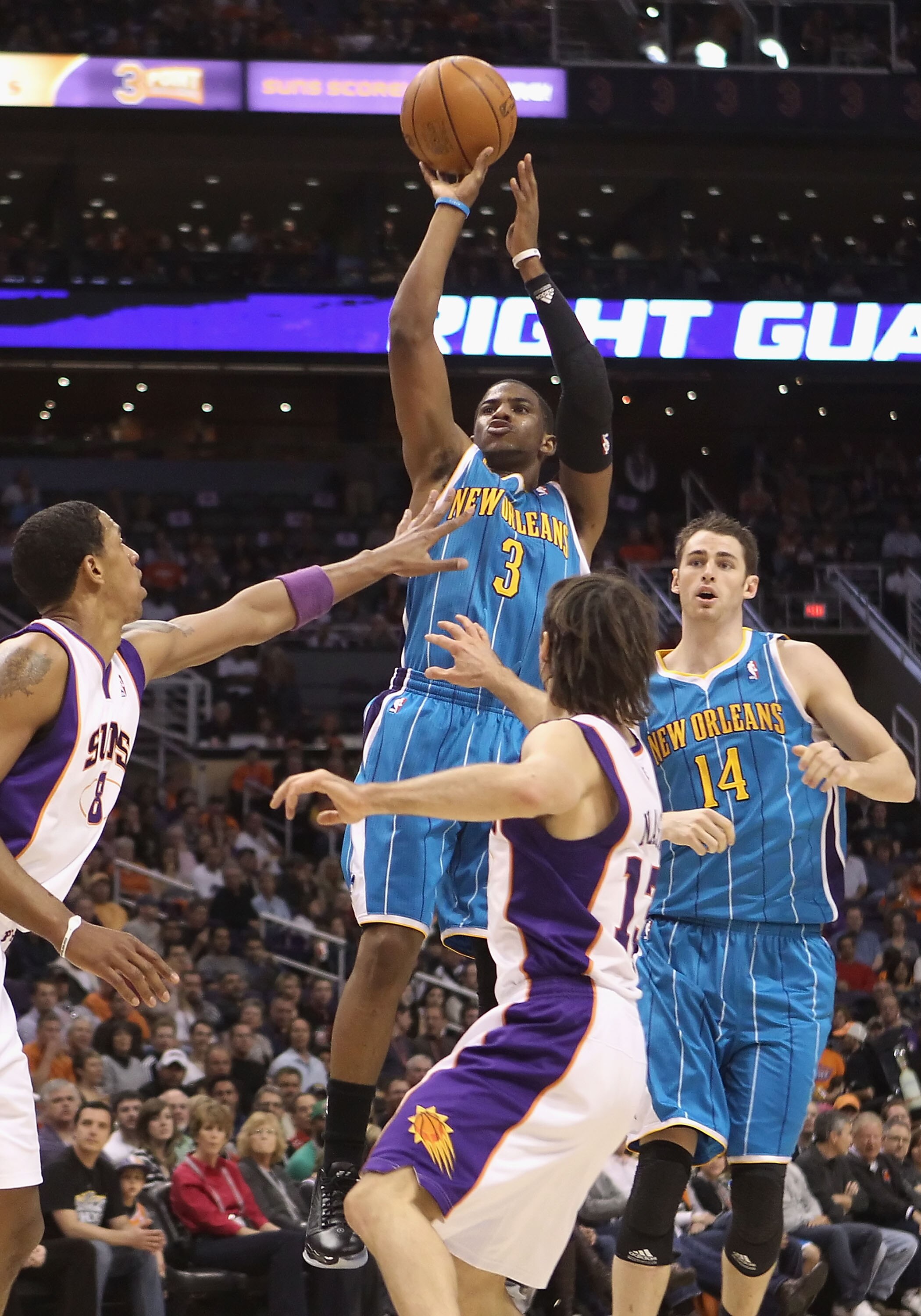 PHOENIX, AZ - JANUARY 30:  Chris Paul #3 of the New Orleans Hornets puts up a shot over Steve Nash #13 and Channing Frye #8 of the Phoenix Suns during the NBA game at US Airways Center on January 30, 2011 in Phoenix, Arizona. The Suns defeated the Hornets