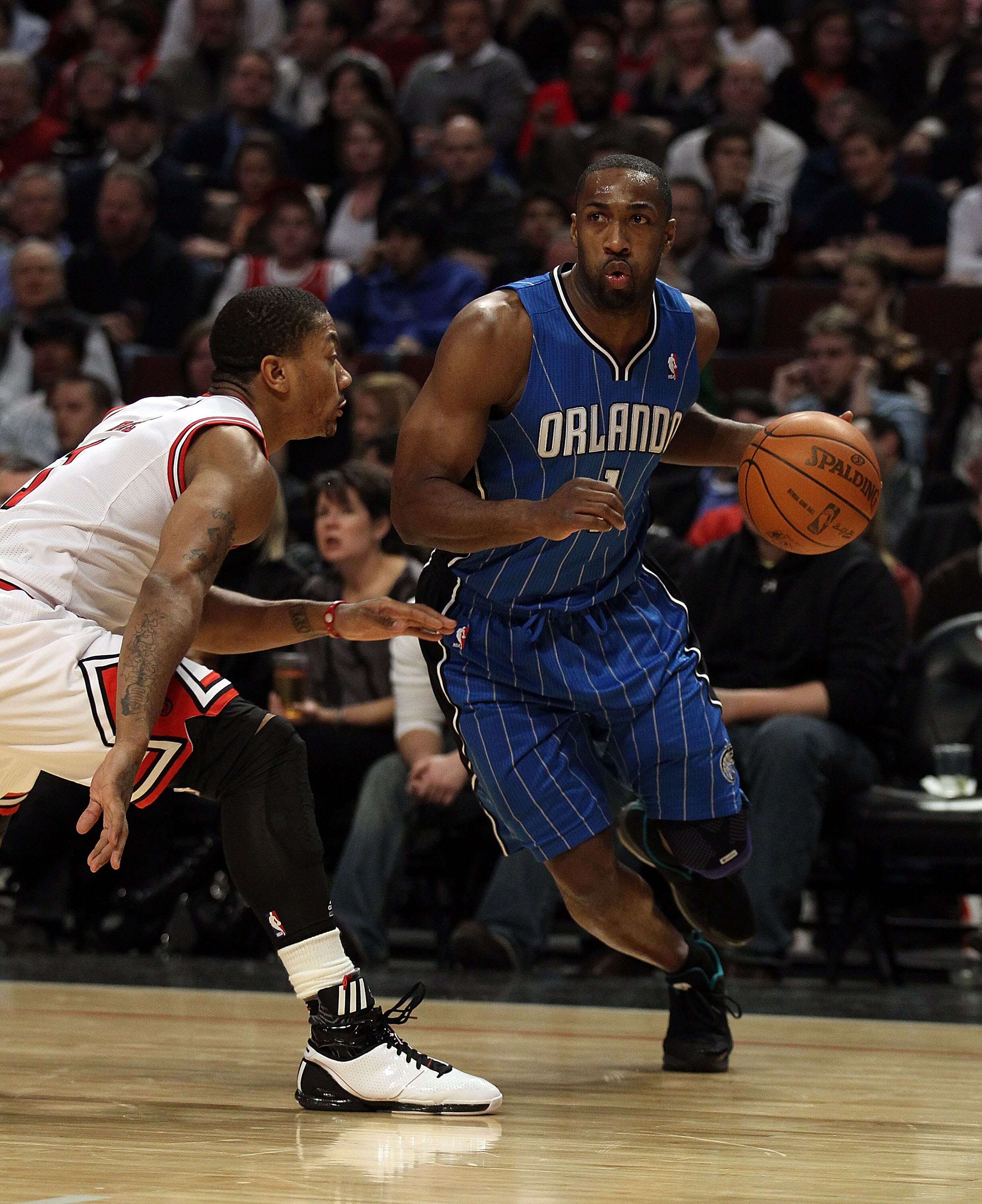 CHICAGO, IL - JANUARY 28: Gilbert Arenas #1 of the Orlando Magic moves against Derrick Rose #1 of the Chicago Bulls at the United Center on January 28, 2011 in Chicago, Illinois. The Bulls defeated the Magic 99-90. NOTE TO USER: User expressly acknowledge