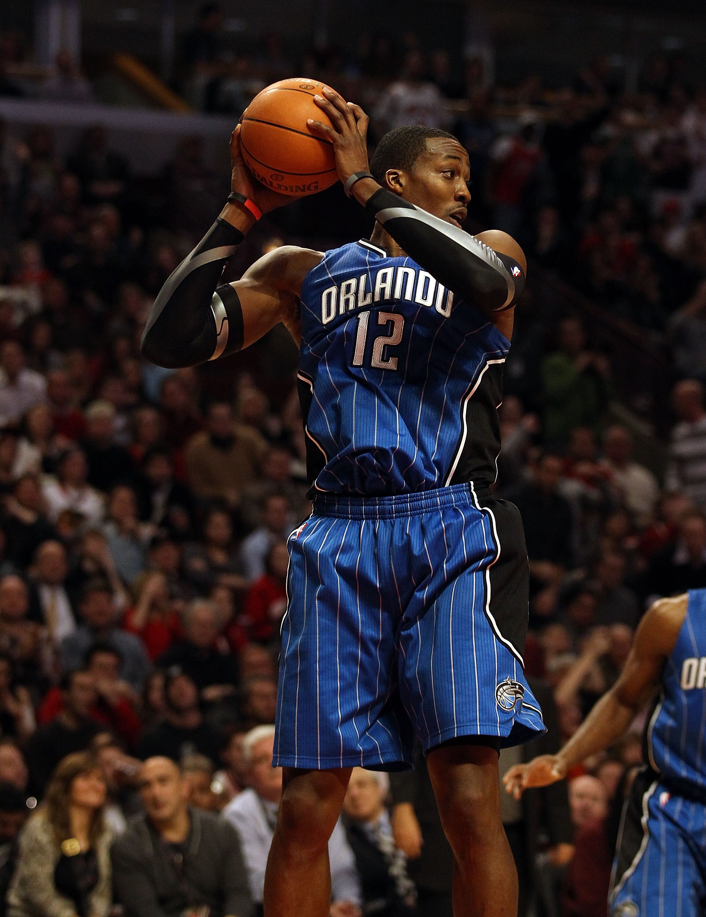 CHICAGO, IL - JANUARY 28: Dwight Howard #12 of the Orlando Magic grabs a rebound against the Chicago Bulls at the United Center on January 28, 2011 in Chicago, Illinois. The Bulls defeated the Magic 99-90. NOTE TO USER: User expressly acknowledges and agr CHICAGO, IL - JANUARY 28: Dwight Howard #12 of the Orlando Magic grabs a rebound against the Chicago Bulls at the United Center on January 28, 2011 in Chicago, Illinois. The Bulls defeated the Magic 99-90. NOTE TO USER: User expressly acknowledges and agr