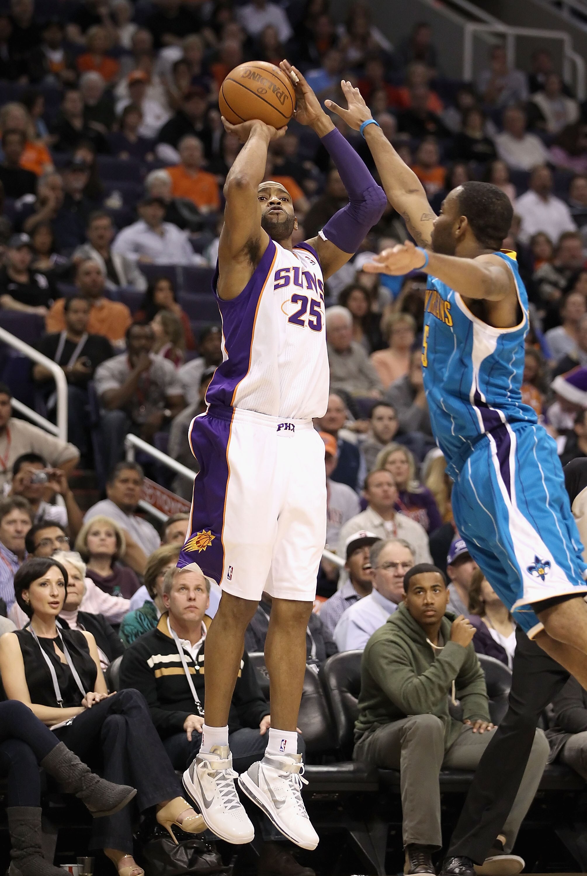 PHOENIX, AZ - JANUARY 30: Vince Carter #25 of the Phoenix Suns attempts a three point shot over Marcus Thornton #5 of the New Orleans Hornets during the NBA game at US Airways Center on January 30, 2011 in Phoenix, Arizona. The Suns defeated the Hornets PHOENIX, AZ - JANUARY 30: Vince Carter #25 of the Phoenix Suns attempts a three point shot over Marcus Thornton #5 of the New Orleans Hornets during the NBA game at US Airways Center on January 30, 2011 in Phoenix, Arizona. The Suns defeated the Hornets