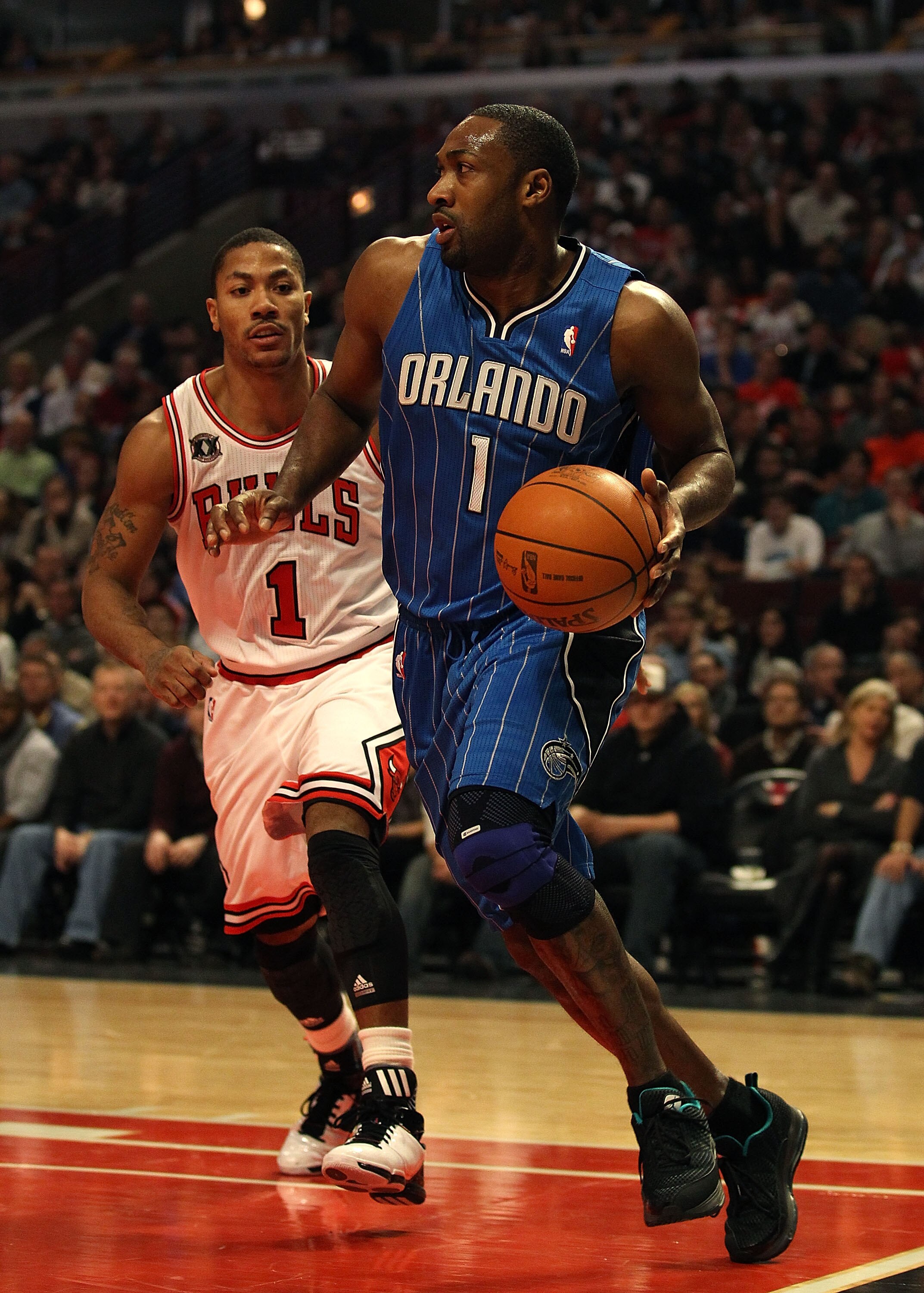 CHICAGO, IL - JANUARY 28: Gilbert Arenas #1 of the Orlando Magic moves past Derrick Rose #1 of the Chicago Bulls at the United Center on January 28, 2011 in Chicago, Illinois. The Bulls defeated the Magic 99-90. NOTE TO USER: User expressly acknowledges a CHICAGO, IL - JANUARY 28: Gilbert Arenas #1 of the Orlando Magic moves past Derrick Rose #1 of the Chicago Bulls at the United Center on January 28, 2011 in Chicago, Illinois. The Bulls defeated the Magic 99-90. NOTE TO USER: User expressly acknowledges a
