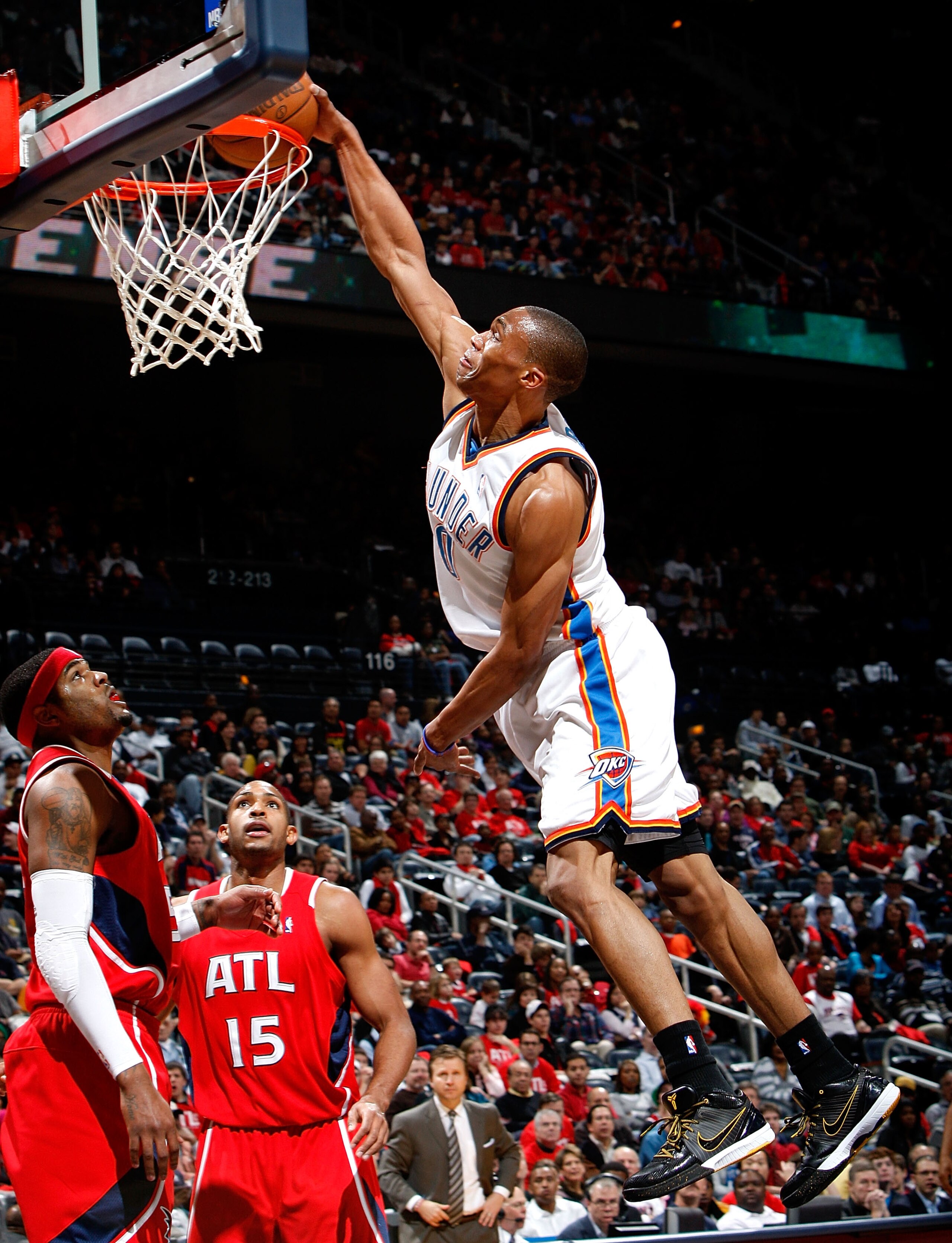 ATLANTA - JANUARY 18:  Russell Westbrook #0 of the Oklahoma City Thunder dunks against Josh Smith #5 and Al Horford #15 of the Atlanta Hawks at Philips Arena on January 18, 2010 in Atlanta, Georgia.  NOTE TO USER: User expressly acknowledges and agrees th