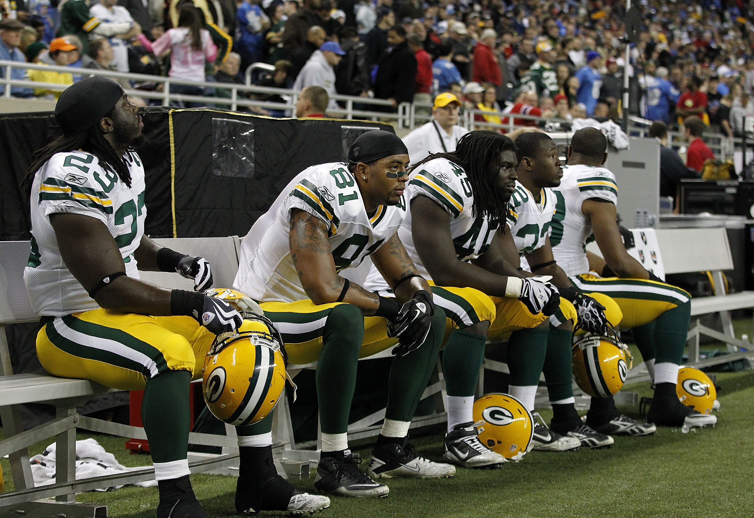 DETROIT - DECEMBER 12: Dimitri Nance #23, Andrew Quarless #81, Quinn Johnson #45 and Pat Lee #22 of the Green Bay Packers sit on the bench after their 7-3 loss to the Detroit Lions at Ford Field on December 12, 2010 in Detroit, Michigan.  (Photo by Leon H