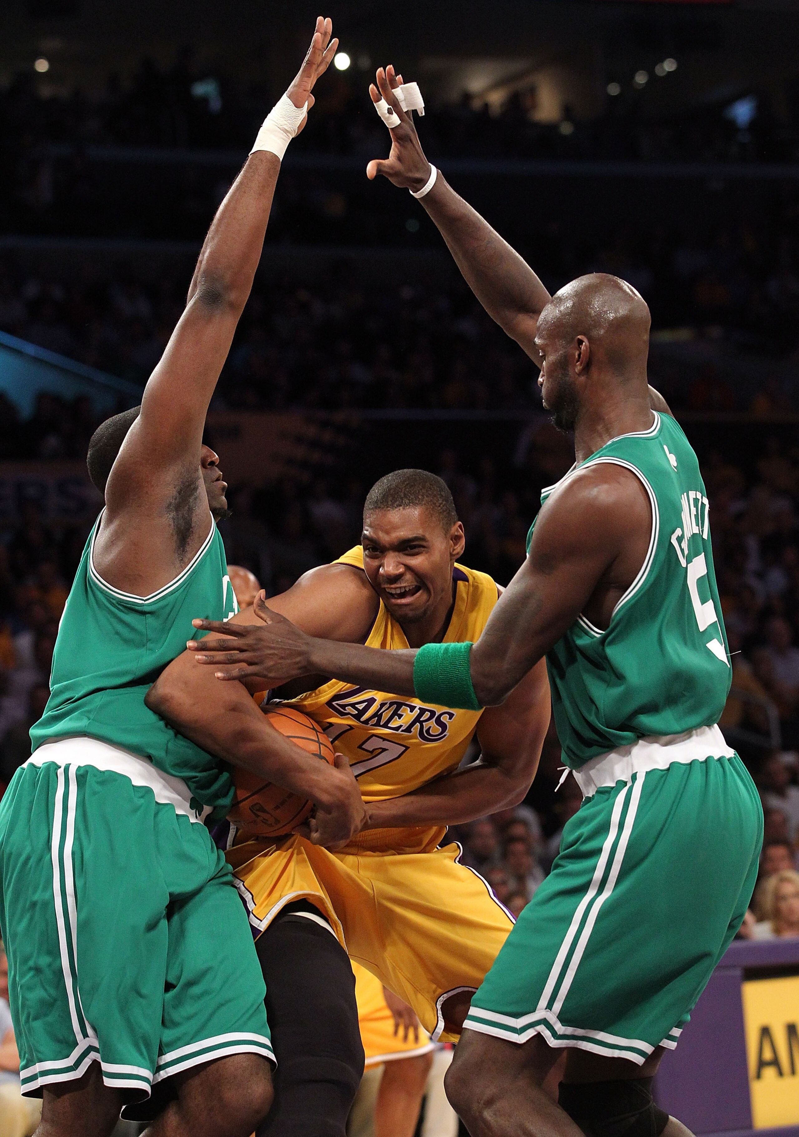 LOS ANGELES, CA - JUNE 15:  Andrew Bynum #17 of the Los Angeles Lakers drives through Kendrick Perkins #43 and Kevin Garnett #5 of the Boston Celtics in the first period of Game Six of the 2010 NBA Finals at Staples Center on June 15, 2010 in Los Angeles,
