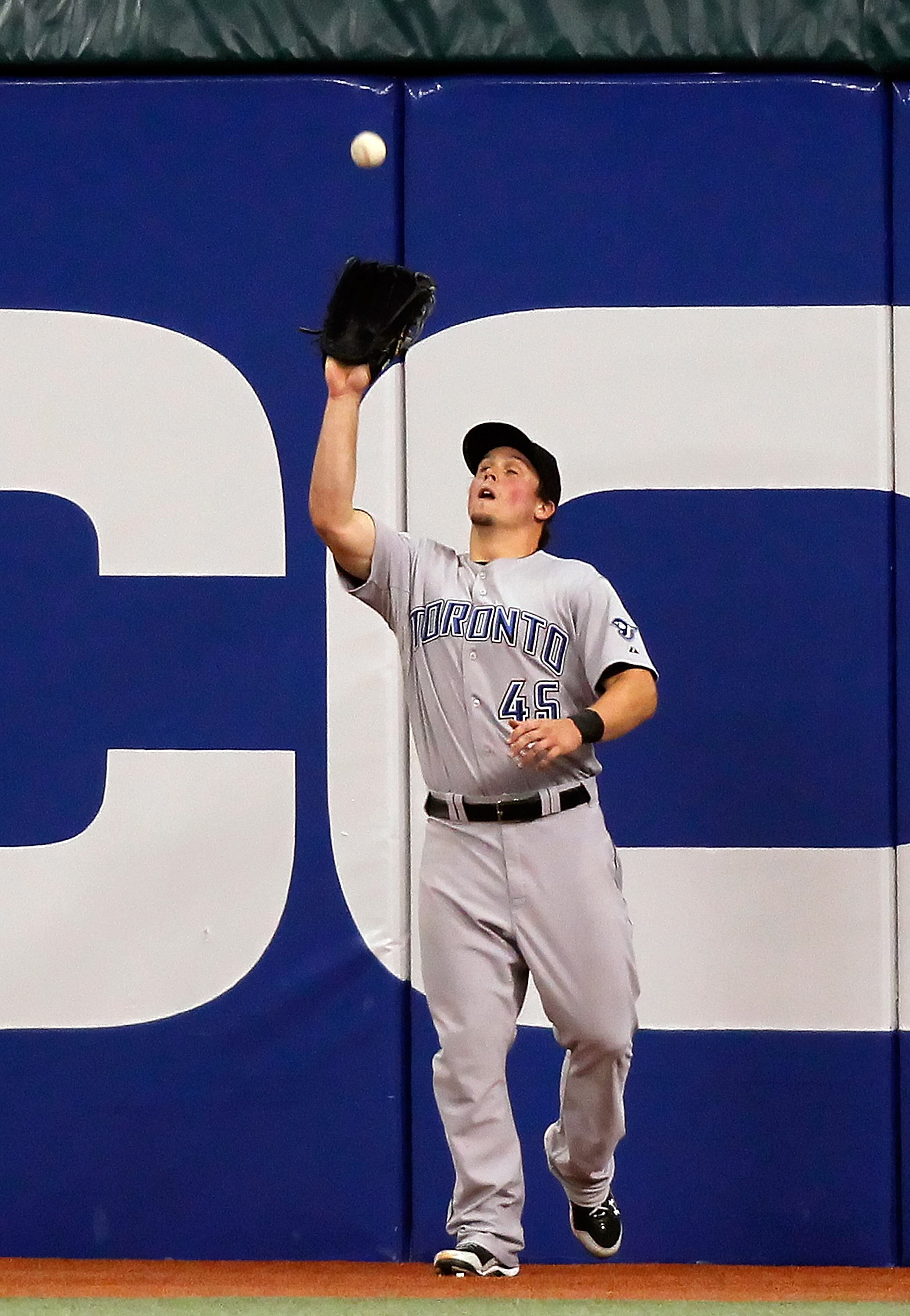ST. PETERSBURG - APRIL 24:  Outfielder Travis Snider #45 of the Toronto Blue Jays catches a fly ball against the Tampa Bay Rays during the game at Tropicana Field on April 24, 2010 in St. Petersburg, Florida.  (Photo by J. Meric/Getty Images)