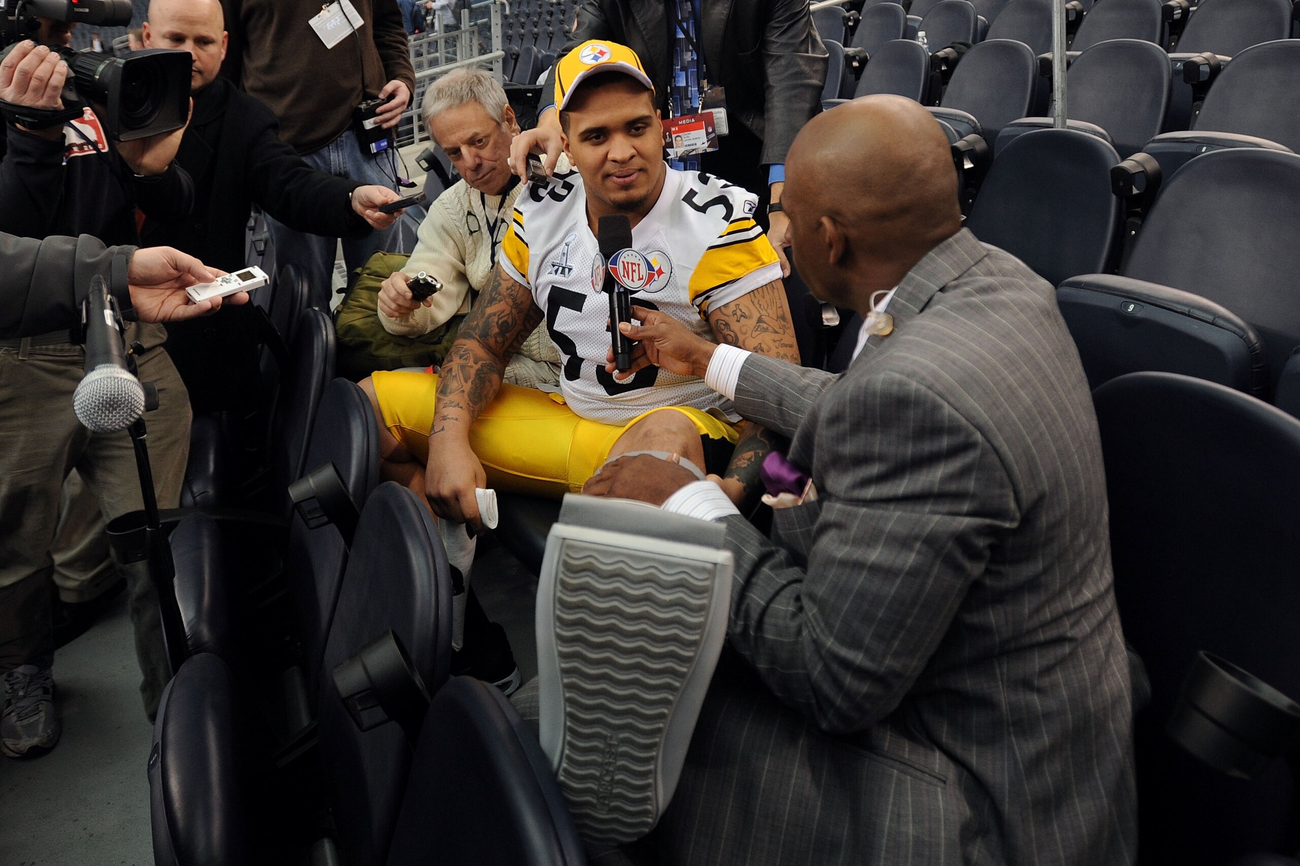 ARLINGTON, TX - FEBRUARY 01:  Maurkice Pouncey #53 of the Pittsburgh Steelers shows NFL Network's Deion Sanders his injured left ankle during Super Bowl XLV Media Day ahead of Super Bowl XLV at Cowboys Stadium on February 1, 2011 in Arlington, Texas. The