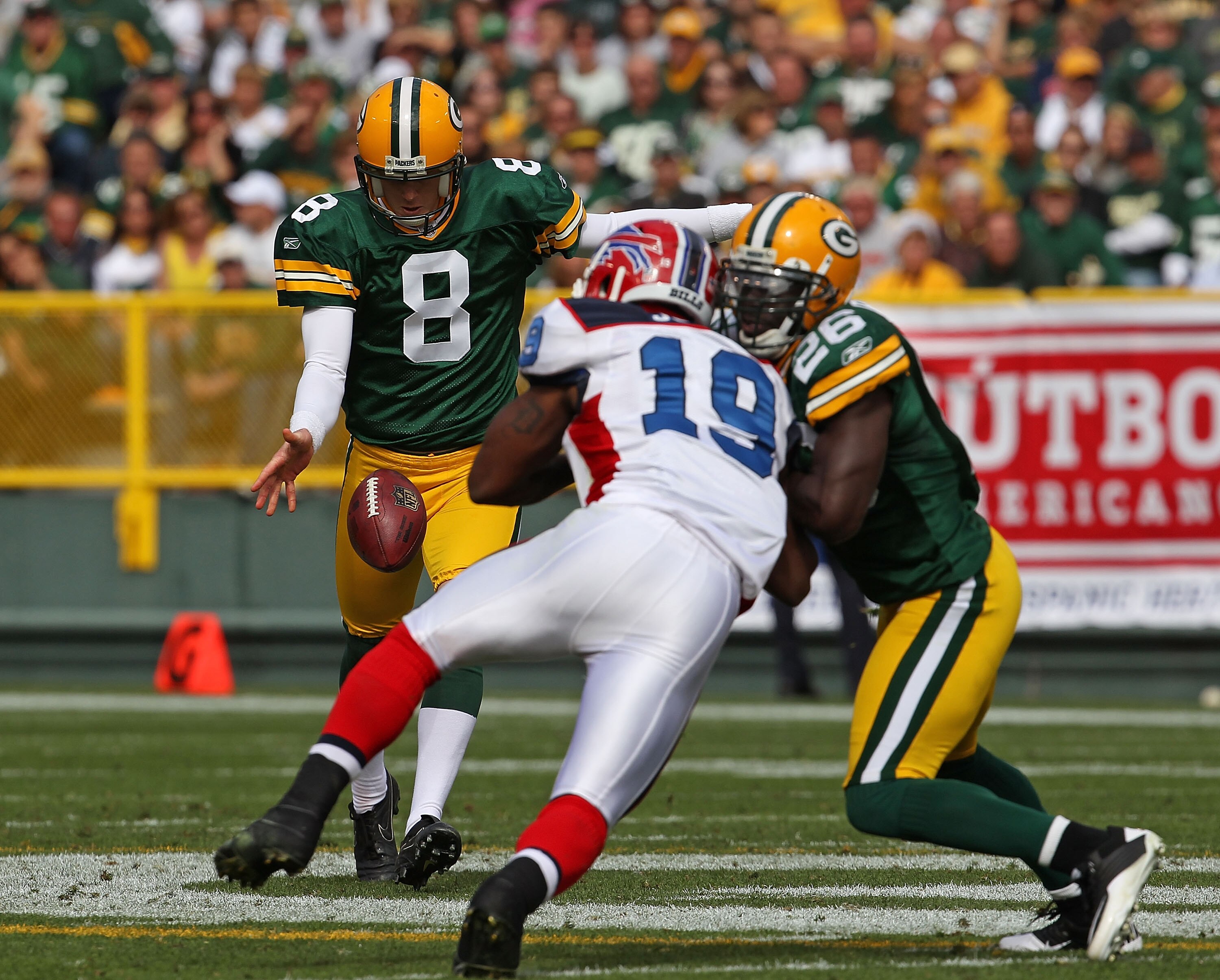 GREEN BAY, WI - SEPTEMBER 19:  Tim Masthay #8 of the Green Bay Packers punts the ball as teammate Charlie Peprah #26 blocks Donald Jones #19 of the Buffalo Bills at Lambeau Field on September 19, 2010 in Green Bay, Wisconsin. The Packers defeated the Bill