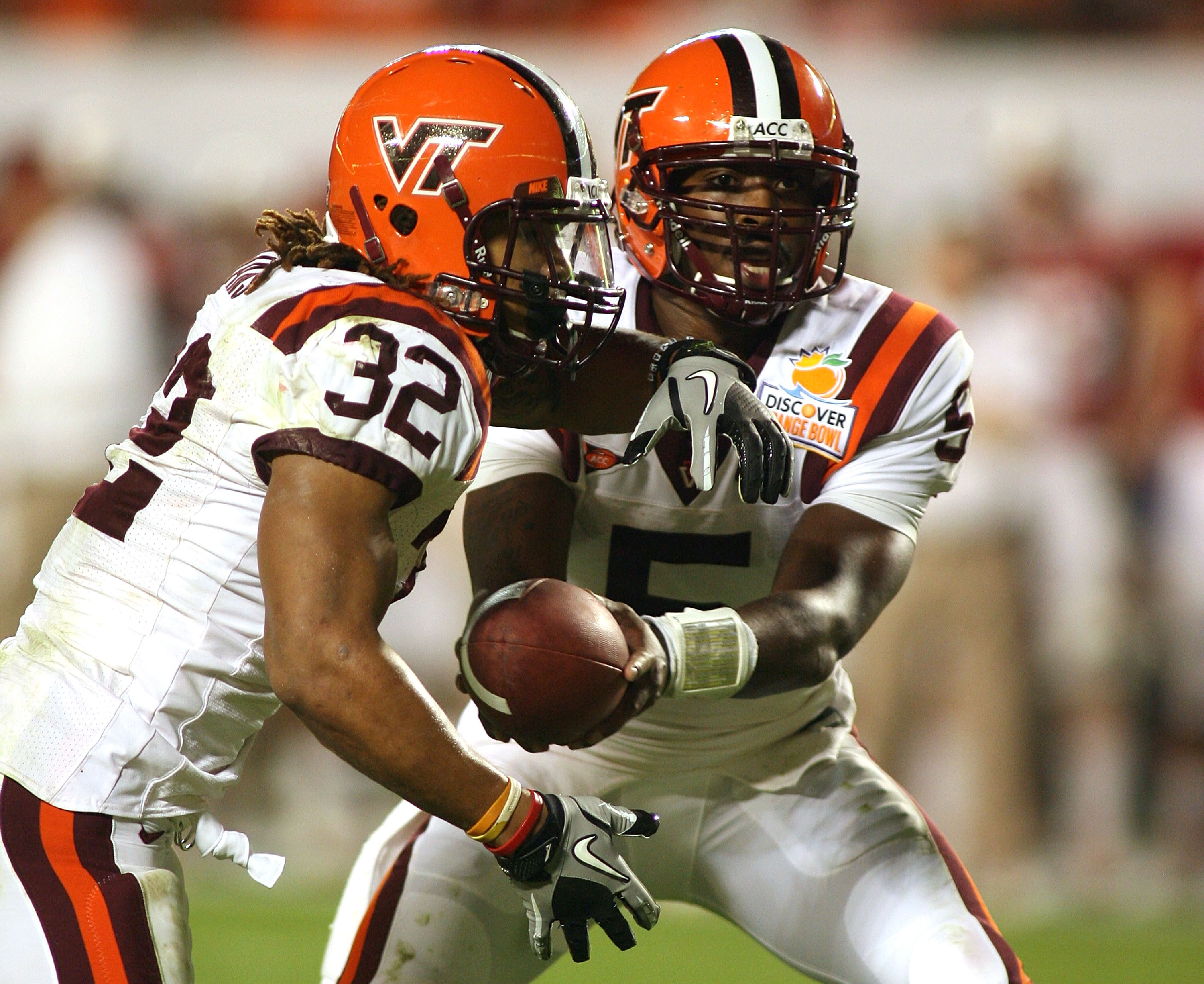 MIAMI, FL - JANUARY 03:  Tyrod Taylor #5 of the Virginia Tech Hokies hands the ball off to Darren Evans #32 against the Stanford Cardinal during the 2011 Discover Orange Bowl at Sun Life Stadium on January 3, 2011 in Miami, Florida. Stanford won 40-12.  (