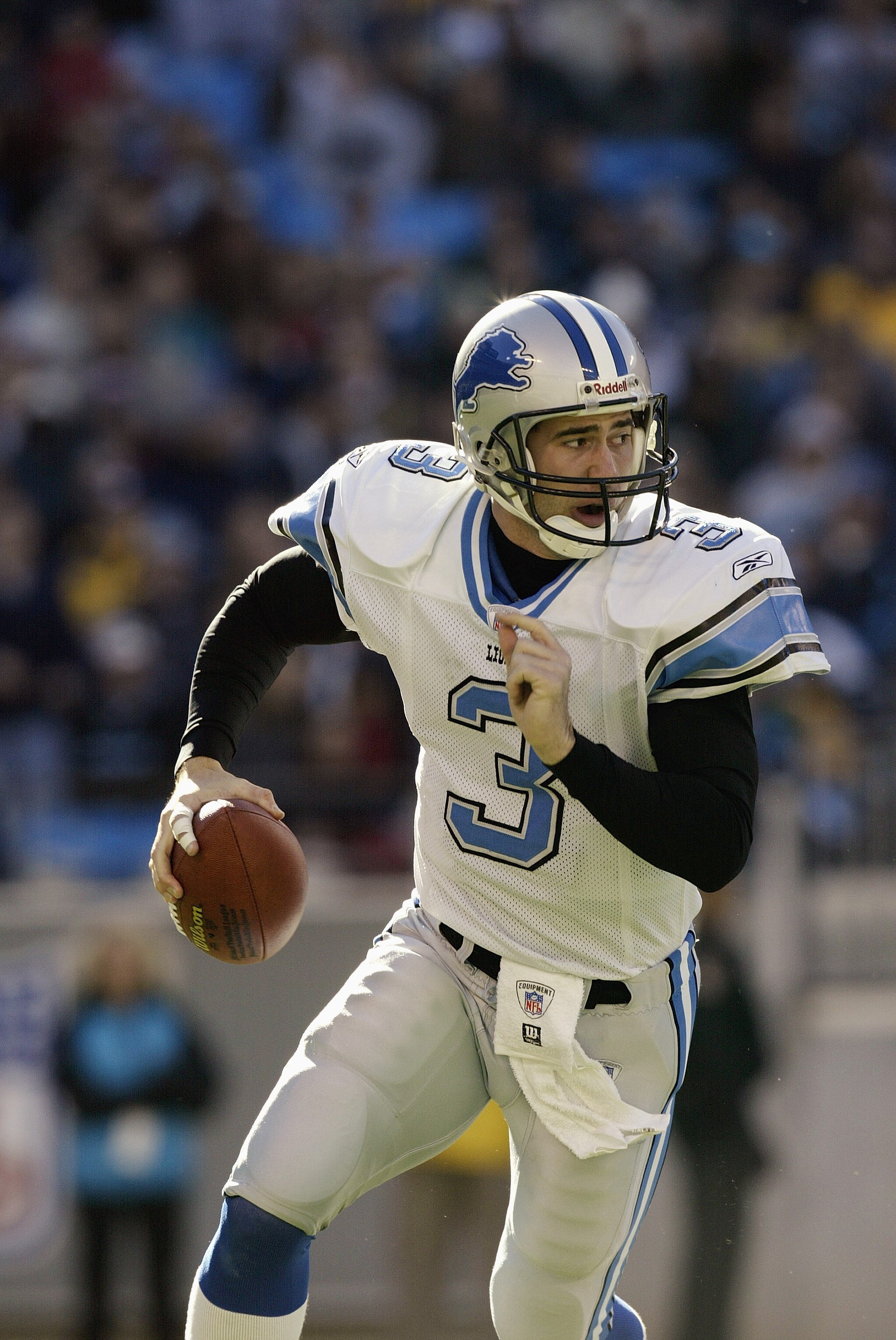 CHARLOTTE, NC - DECEMBER 21:  Quarterback Joey Harrington #3 of the Detroit Lions rolls out to pass during the game against the Carolina Panthers on December 21, 2003 at Ericsson Stadium in Charlotte, North Carolina. The Panthers defeated the Lions 20-14.