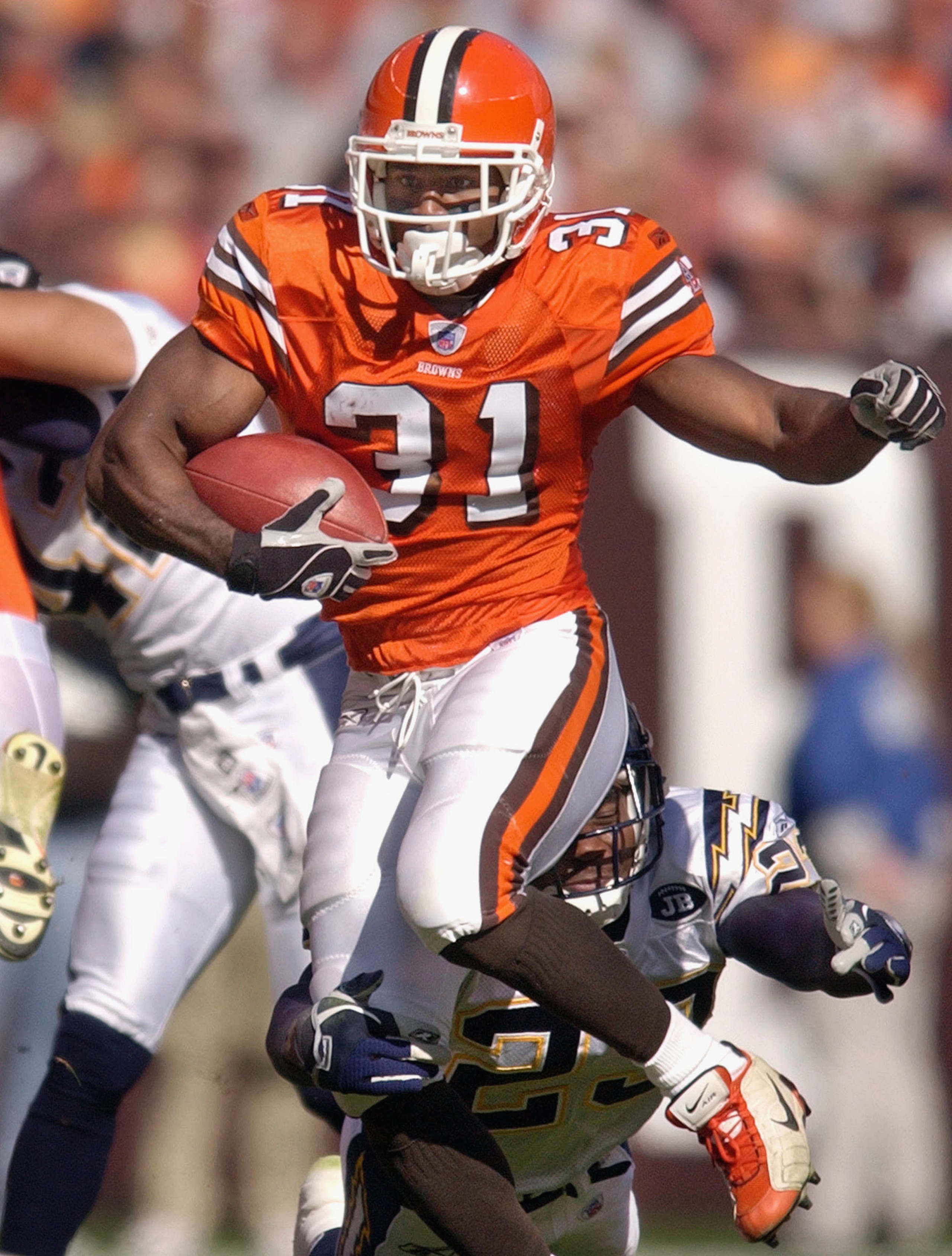CLEVELAND, OH - OCTOBER 19:  Running back William Green #31 of the Cleveland Browns is tackled by cornerback Quentin Jammer #23 of the San Diego Chargers on October 19, 2003 at Cleveland Browns Stadium in Cleveland, Ohio. The Chargers defeated the Browns