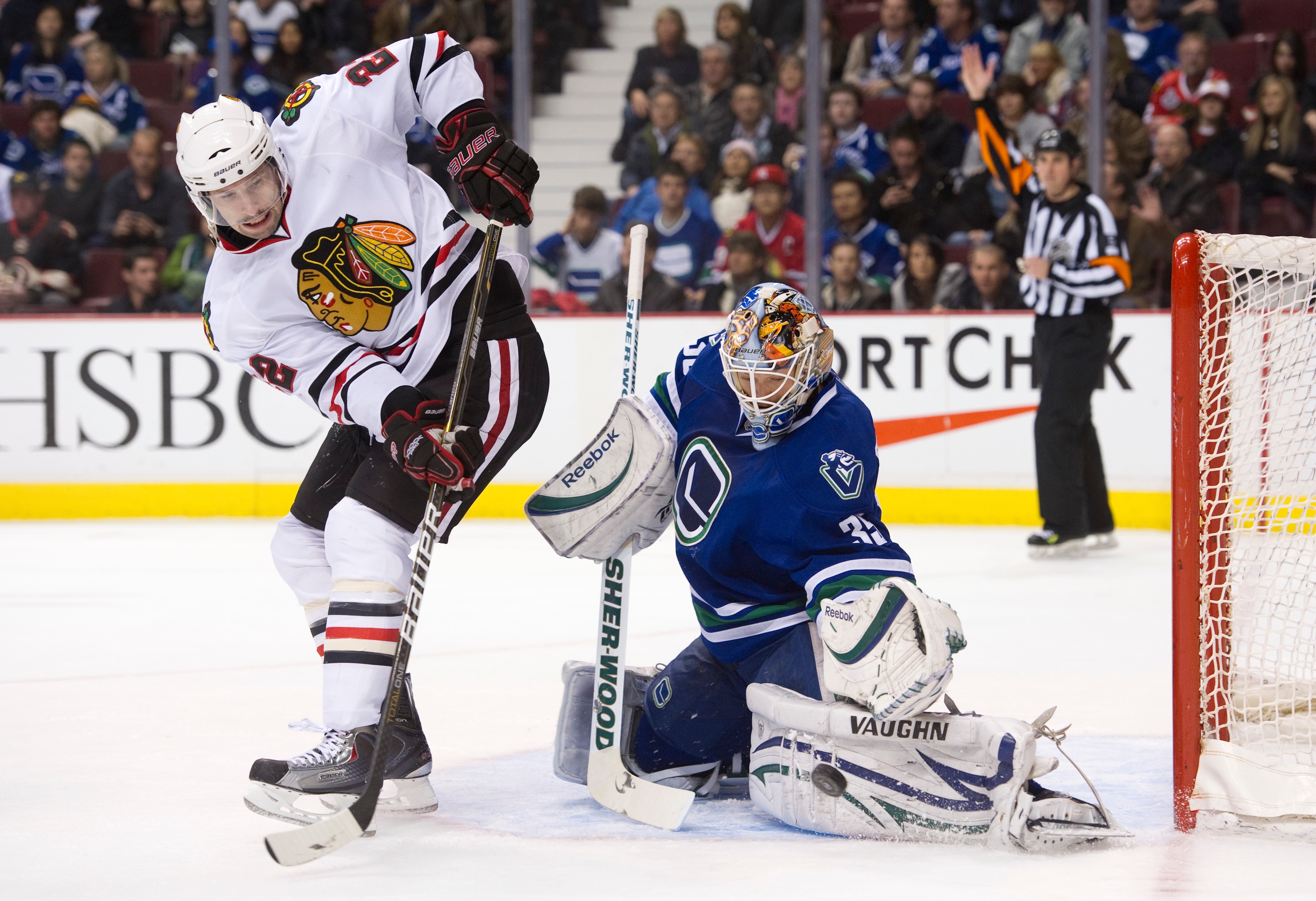 VANCOUVER, CANADA - NOVEMBER 20: Goalie Cory Schneider #35 of the Vancouver Canucks makes a pad save of the deflection by Troy Brouwer #22 of the Chicago Blackhawks during the third period in NHL action on November 20, 2010 at Rogers Arena in Vancouver, B