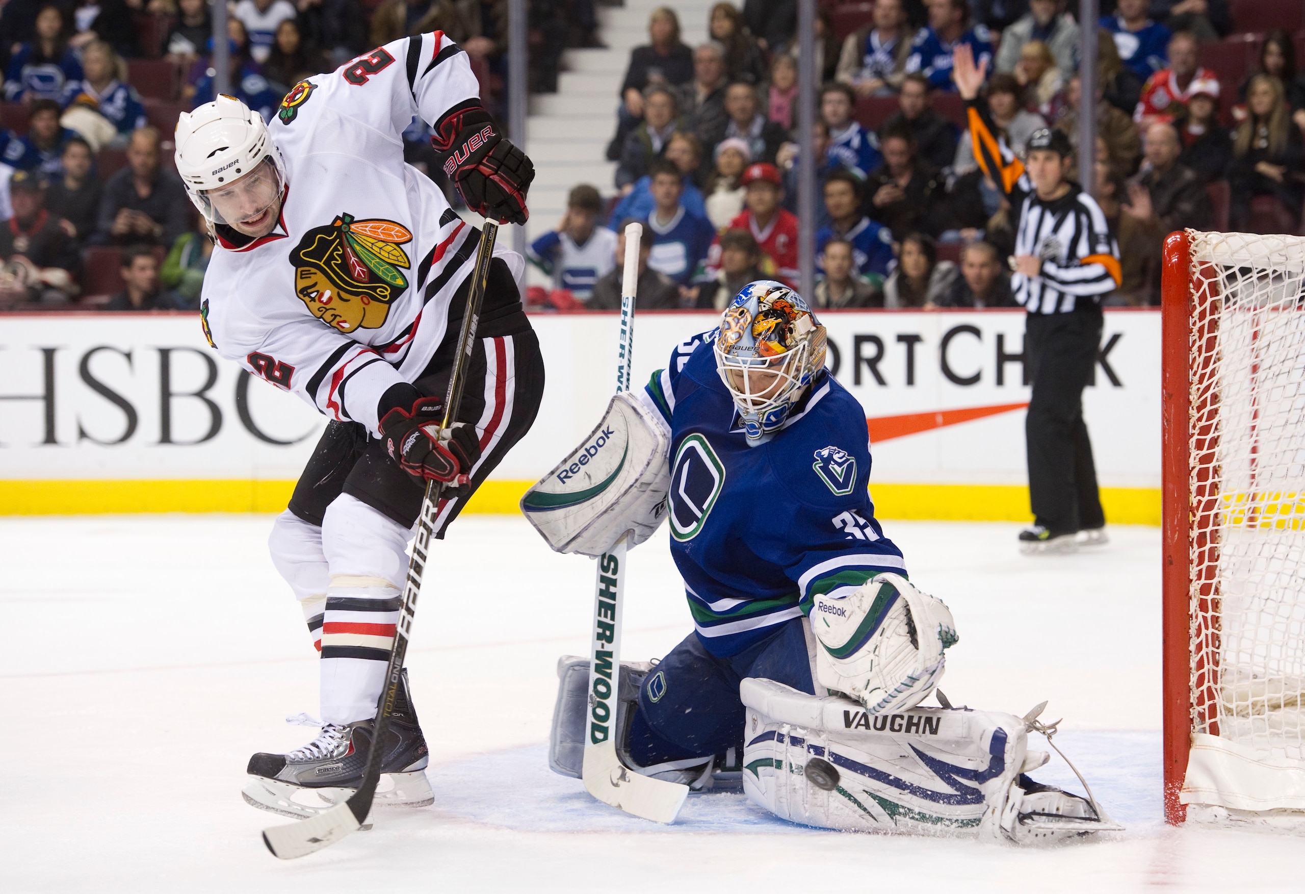 VANCOUVER, CANADA - NOVEMBER 20: Goalie Cory Schneider #35 of the Vancouver Canucks makes a pad save of the deflection by Troy Brouwer #22 of the Chicago Blackhawks during the third period in NHL action on November 20, 2010 at Rogers Arena in Vancouver, B