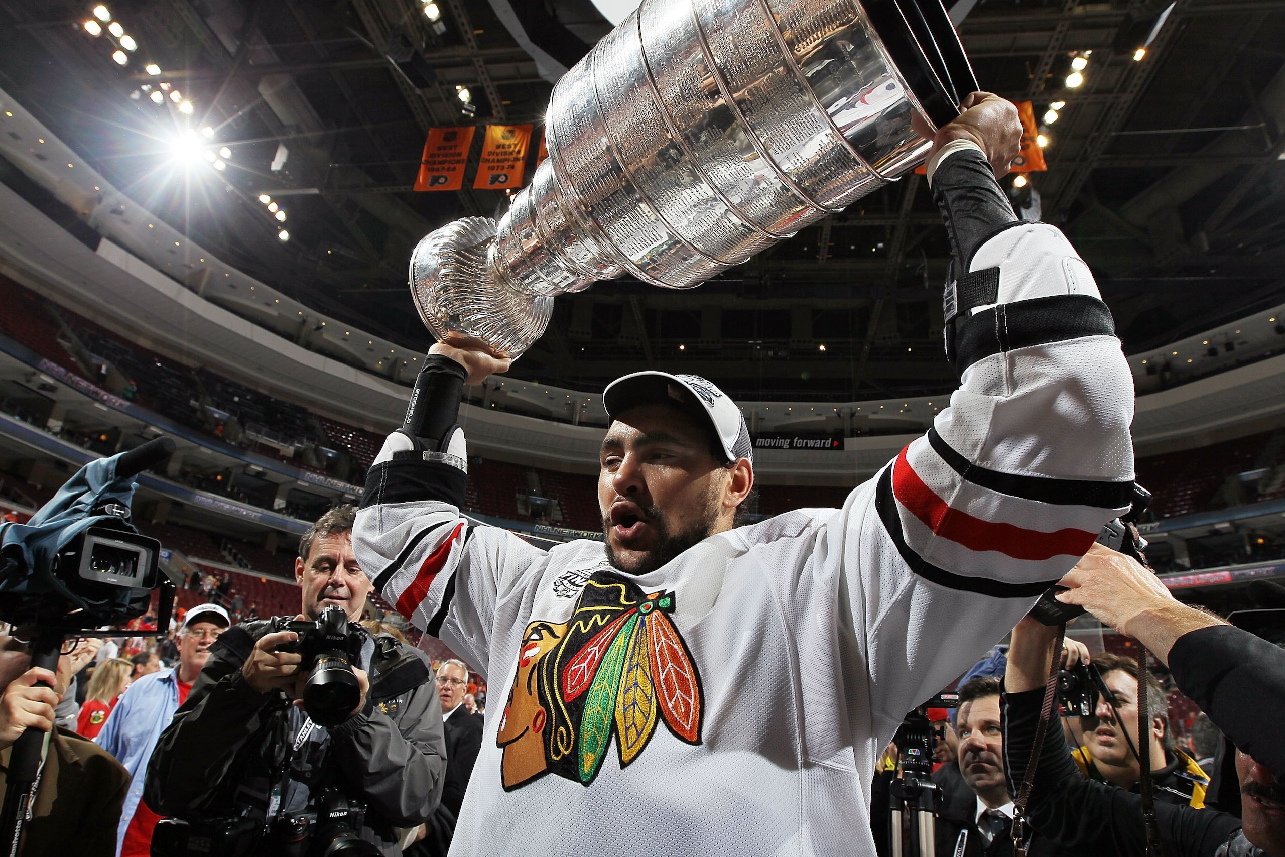 PHILADELPHIA - JUNE 09:  Dustin Byfuglien #33 of the Chicago Blackhawks hoists the Stanley Cup after teammate Patrick Kane scored the game-winning goal in overtime to defeat the Philadelphia Flyers 4-3 and win the Stanley Cup in Game Six of the 2010 NHL S