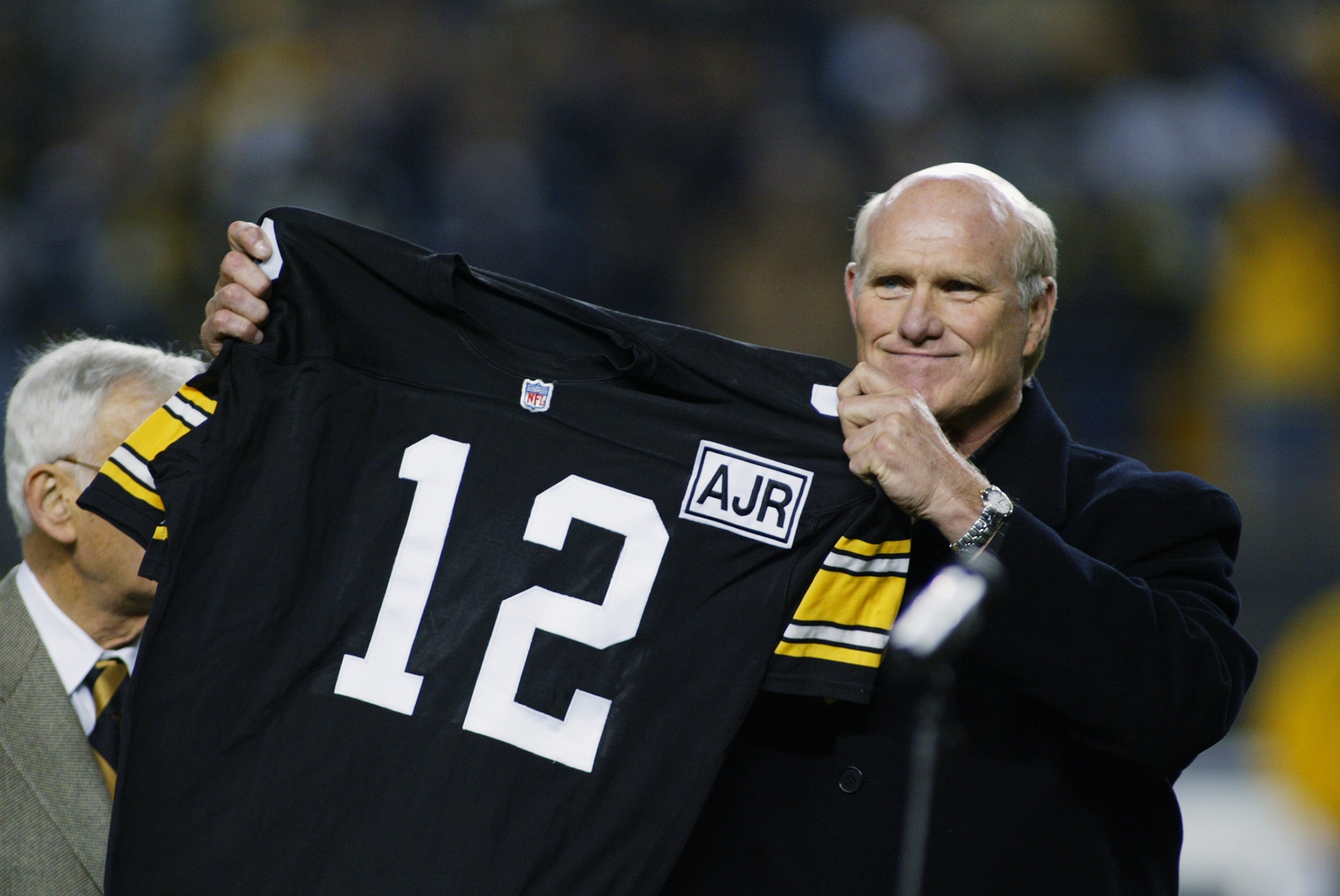 PITTSBURGH, PA - OCTOBER 21: Retired Quarterback Terry Bradshaw of the Pittsburgh Steelers holds up his old number during the NFL game against the Indianapolis Colts at Heinz Field on October 21, 2002 in Pittsburgh, Pennsylvania. Pittsburgh won 28-10.(P PITTSBURGH, PA - OCTOBER 21: Retired Quarterback Terry Bradshaw of the Pittsburgh Steelers holds up his old number during the NFL game against the Indianapolis Colts at Heinz Field on October 21, 2002 in Pittsburgh, Pennsylvania. Pittsburgh won 28-10.(P