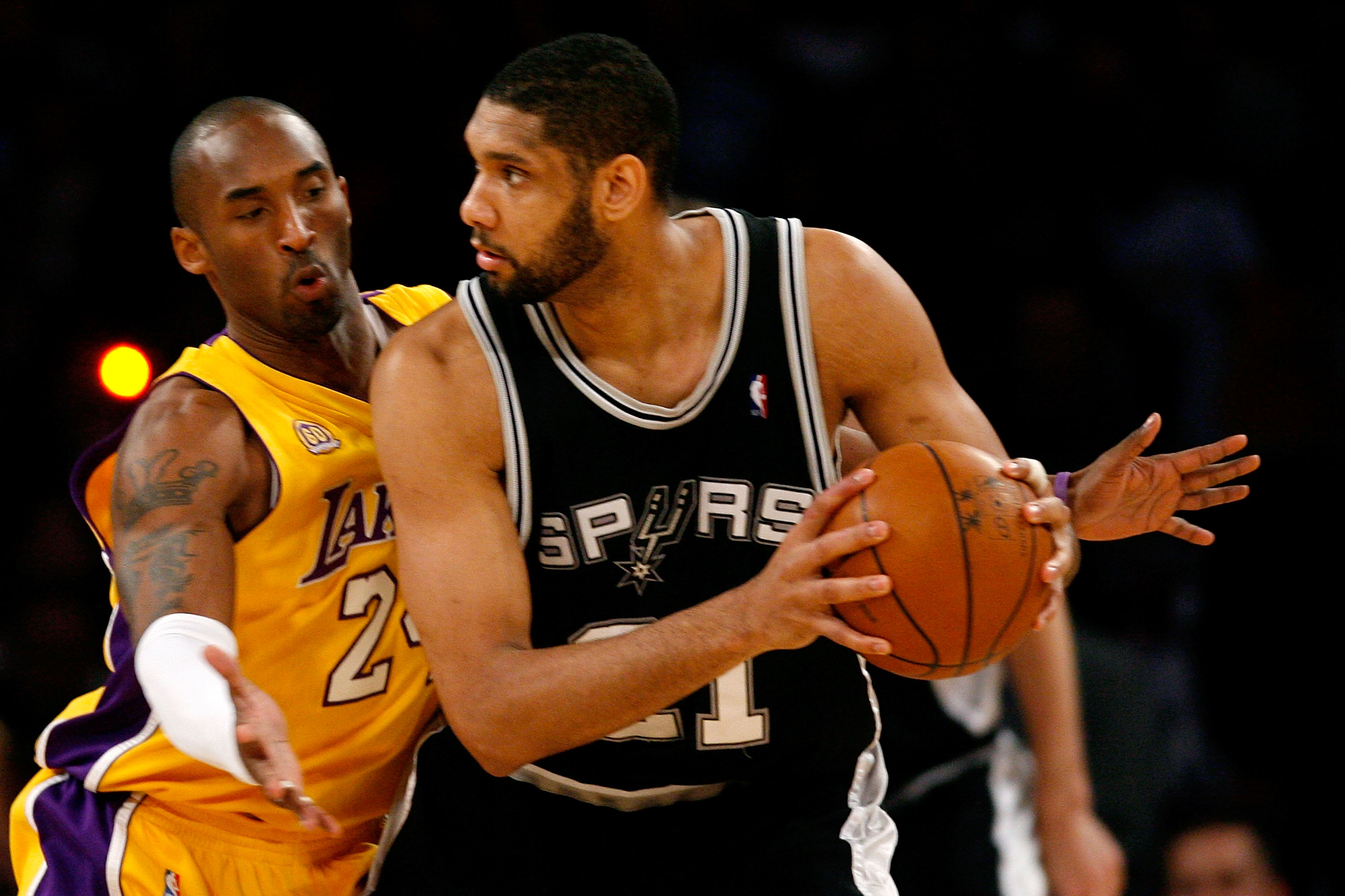 LOS ANGELES, CA - MAY 23:  Tim Duncan #21 of the San Antonio Spurs looks to pass over Kobe Bryant #24 of the Los Angeles Lakers in Game Two of the Western Conference Finals during the 2008 NBA Playoffs on May 23, 2008 at Staples Center in Los Angeles, Cal
