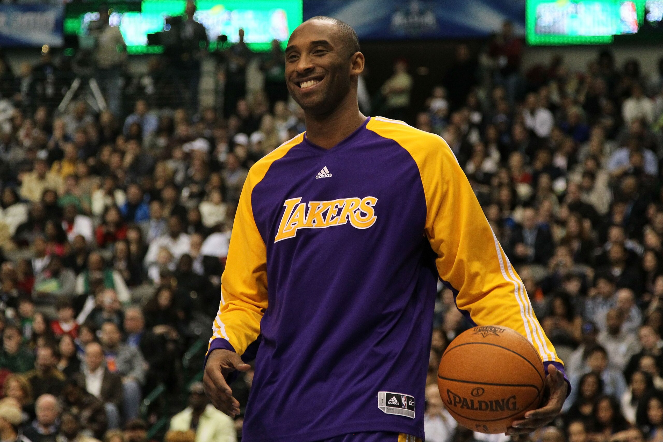DALLAS - FEBRUARY 13: Kobe Bryant #24 of the Los Angeles Lakers smiles while on court to assist teammate Shannon Brown #12 during the Sprite Slam Dunk Contest on All-Star Saturday Night, part of 2010 NBA All-Star Weekend at American Airlines Center on Fe DALLAS - FEBRUARY 13: Kobe Bryant #24 of the Los Angeles Lakers smiles while on court to assist teammate Shannon Brown #12 during the Sprite Slam Dunk Contest on All-Star Saturday Night, part of 2010 NBA All-Star Weekend at American Airlines Center on Fe