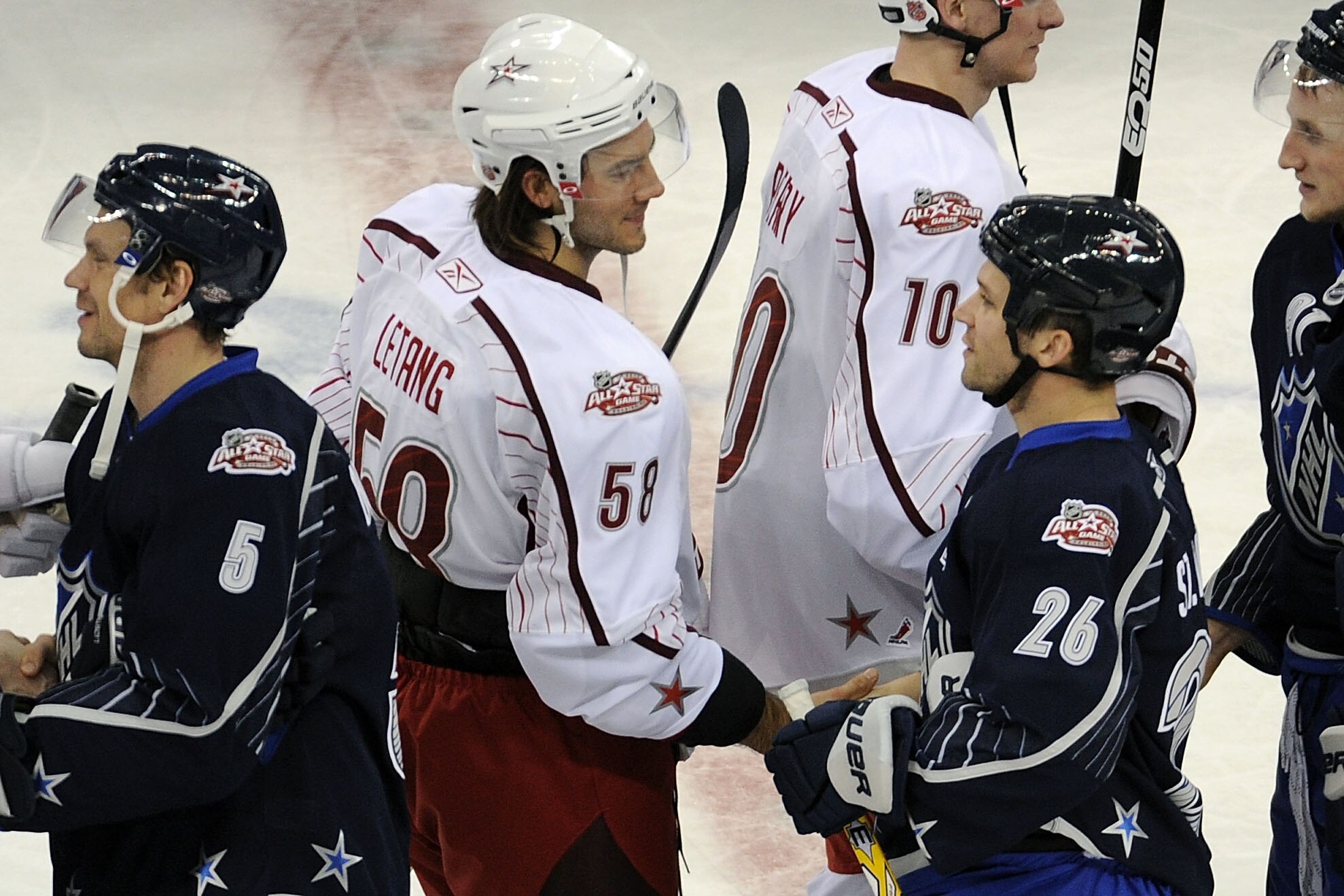 RALEIGH, NC - JANUARY 30:  Kris Letang #58 of the Pittsburgh Penguins and Team Staal shakes hands with Martin St. Louis #26 of the Tampa Bay Lightning and Team Lidstrom after Team Lidstrom defeated Team Staal 11 to 10 in the 58th NHL All-Star Game at RBC