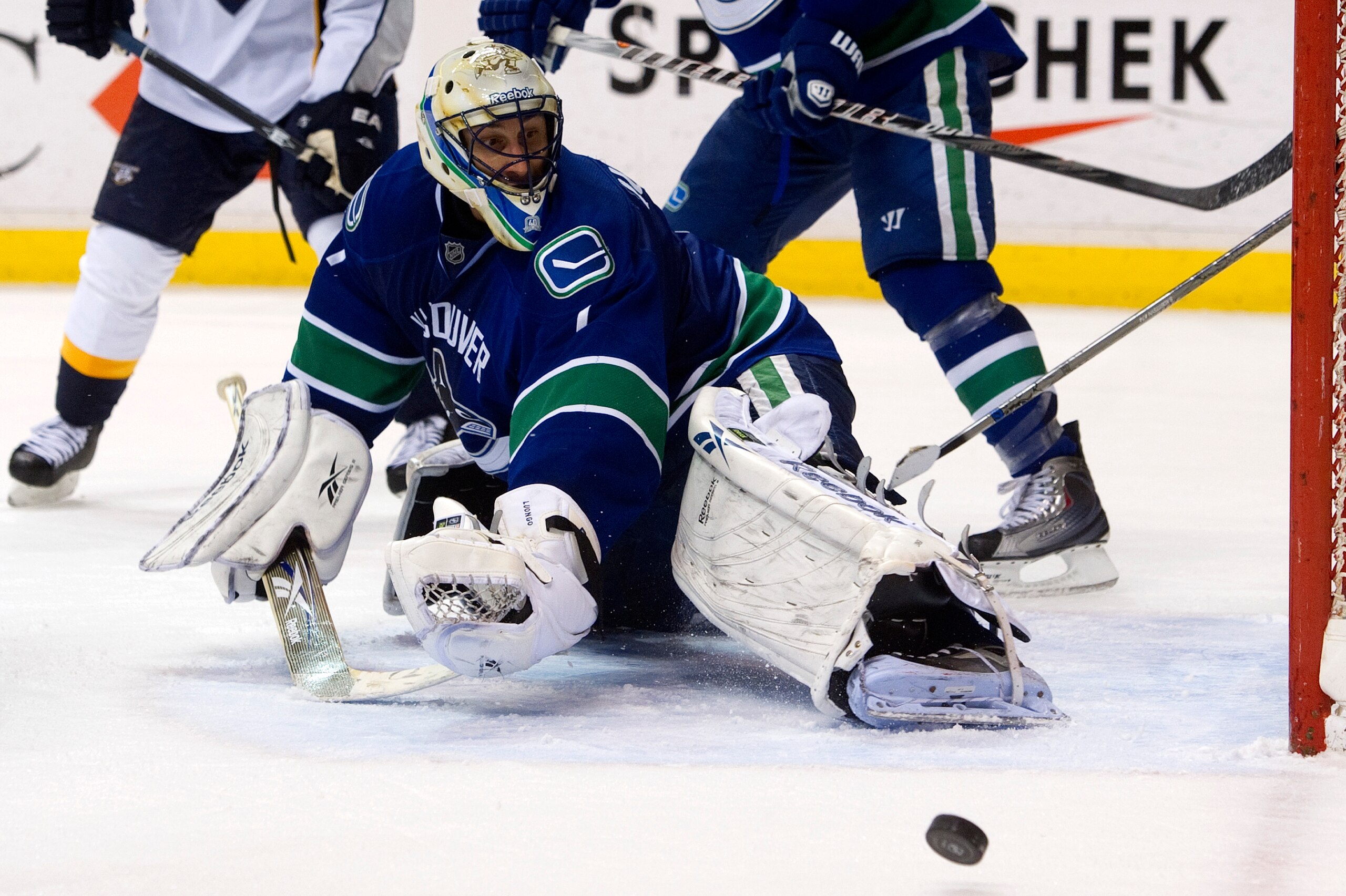 VANCOUVER, CANADA - JANUARY 26: Goalie Roberto Luongo #1 of the Vancouver Canucks watches the puck roll into the corner after making a pad save against the Nashville Predators during the last minute of the third period in NHL action on January 26, 2011 at