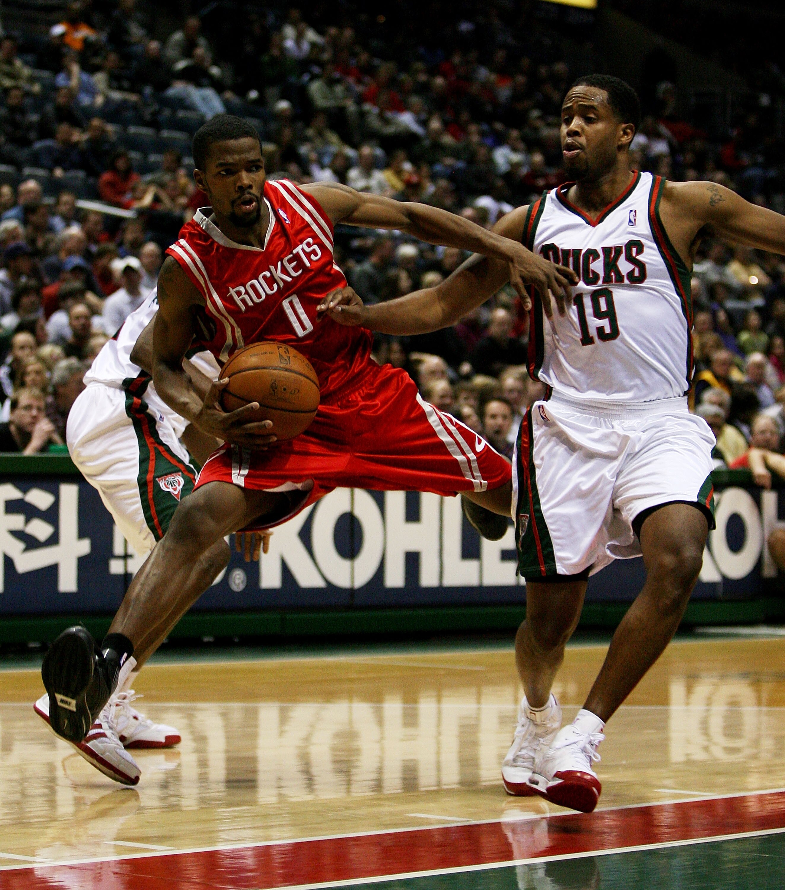 MILWAUKEE - FEBRUARY 09: Aaron Brooks #0 of the Houston Rockets tries to move around Damon Jones #19 of the Milwaukee Bucks on February 9, 2009 at the Bradley Center in Milwaukee, Wisconsin. NOTE TO USER: User expressly acknowledges and agreees that, by d