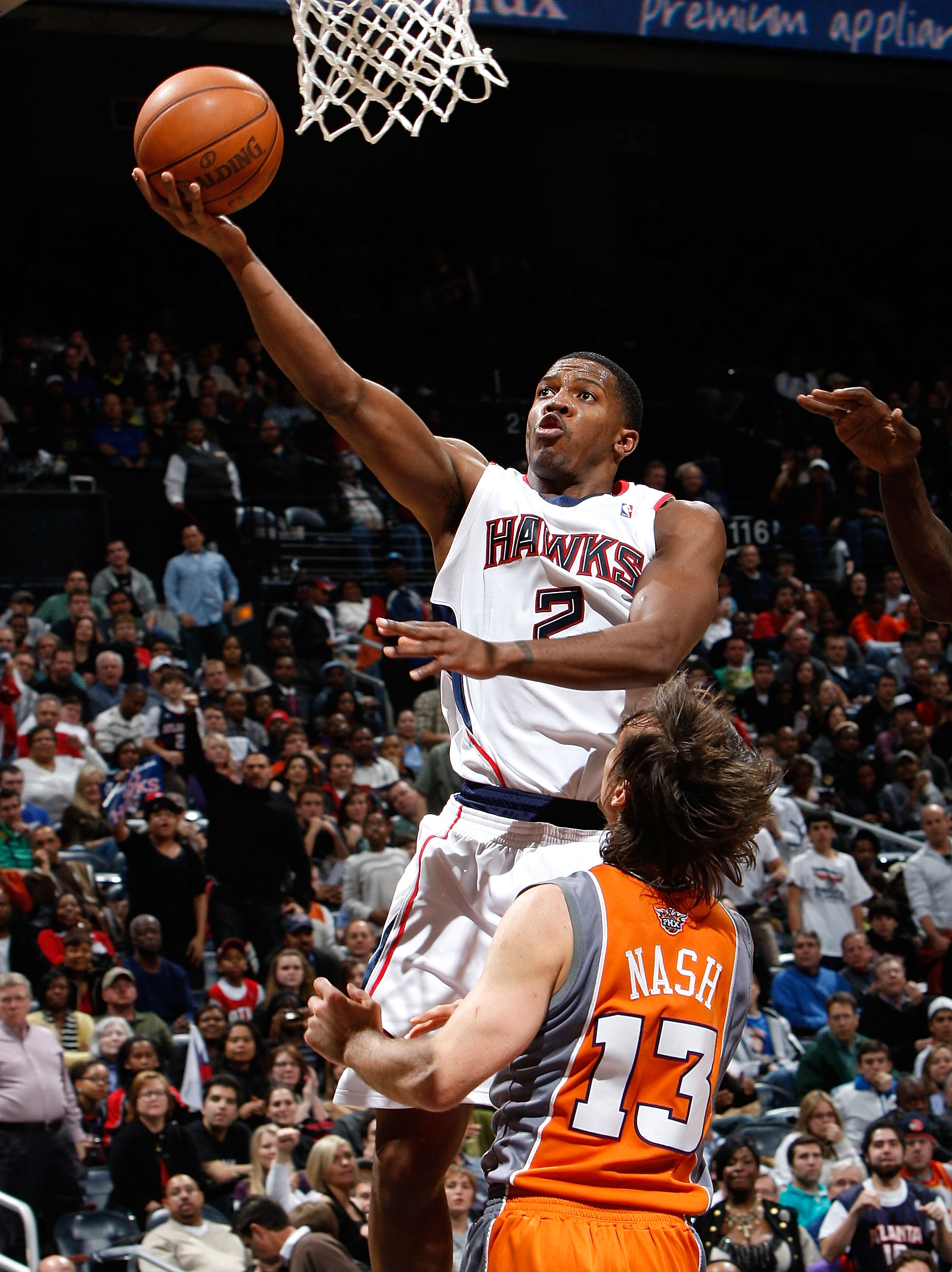 ATLANTA - JANUARY 15:  Joe Johnson #2 of the Atlanta Hawks lays in a basket against Steve Nash #13 of the Phoenix Suns at Philips Arena on January 15, 2010 in Atlanta, Georgia.  NOTE TO USER: User expressly acknowledges and agrees that, by downloading and
