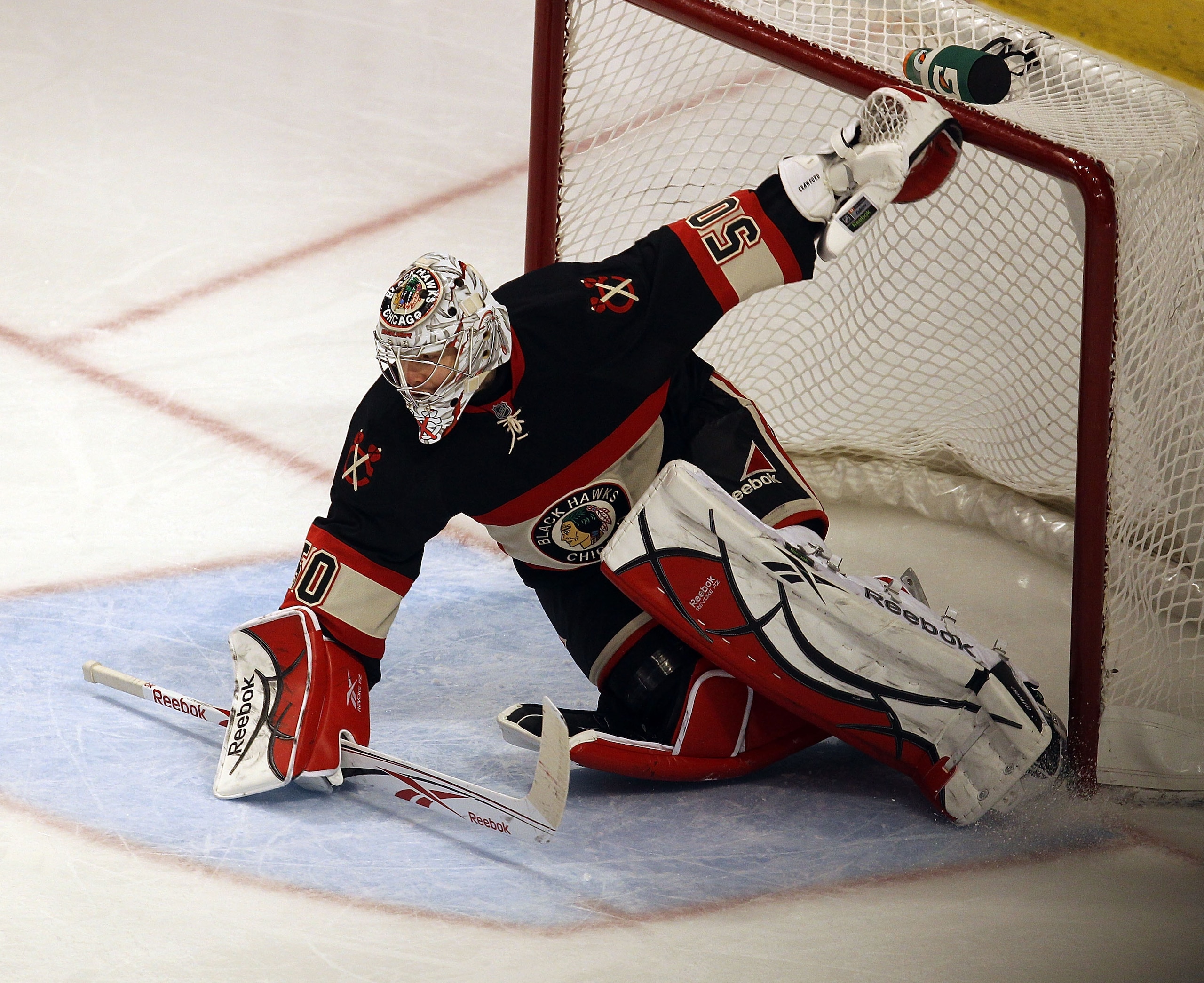 CHICAGO, IL - JANUARY 25: Corey Crawforsd #50 of the Chicago Blackhawks dives to stop the puck against the Minnesota Wild at the United Center on January 25, 2011 in Chicago, Illinois. The Wild defeated the Blackhawks 4-2. (Photo by Jonathan Daniel/Getty