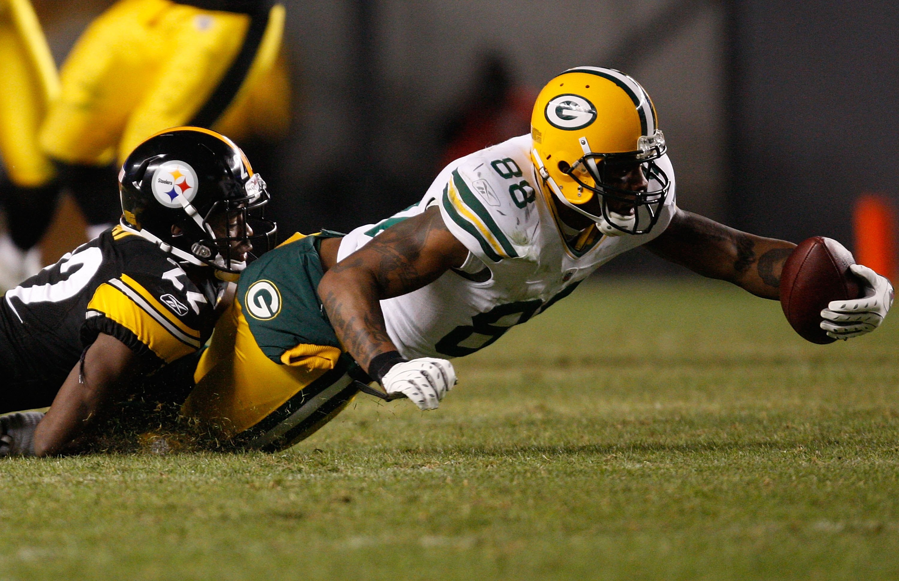 PITTSBURGH - DECEMBER 20: Jermichael Finley #88 of the Green Bay Packers stretches the ball out after being tackled by William Gay #22 of the Pittsburgh Steelers during the game on December 20, 2009 at Heinz Field in Pittsburgh, Pennsylvania. (Photo by Ja