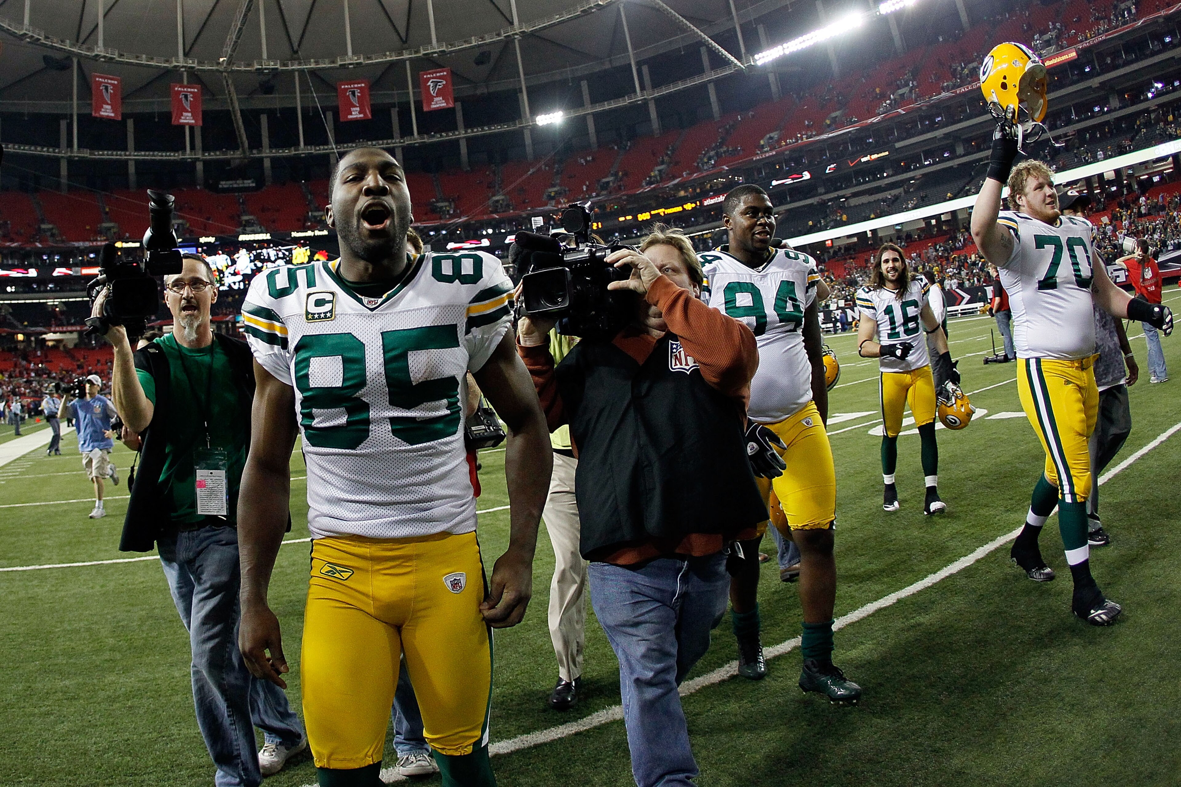 ATLANTA, GA - JANUARY 15:  (L-R) Greg Jennings #85, Jarius Wynn #94, Brett Swain #16 and T.J. Lang #70 of the Green Bay Packers celebrate as they walk off the field after the Packers won 48-21 against the Atlanta Falcons during their 2011 NFC divisional p