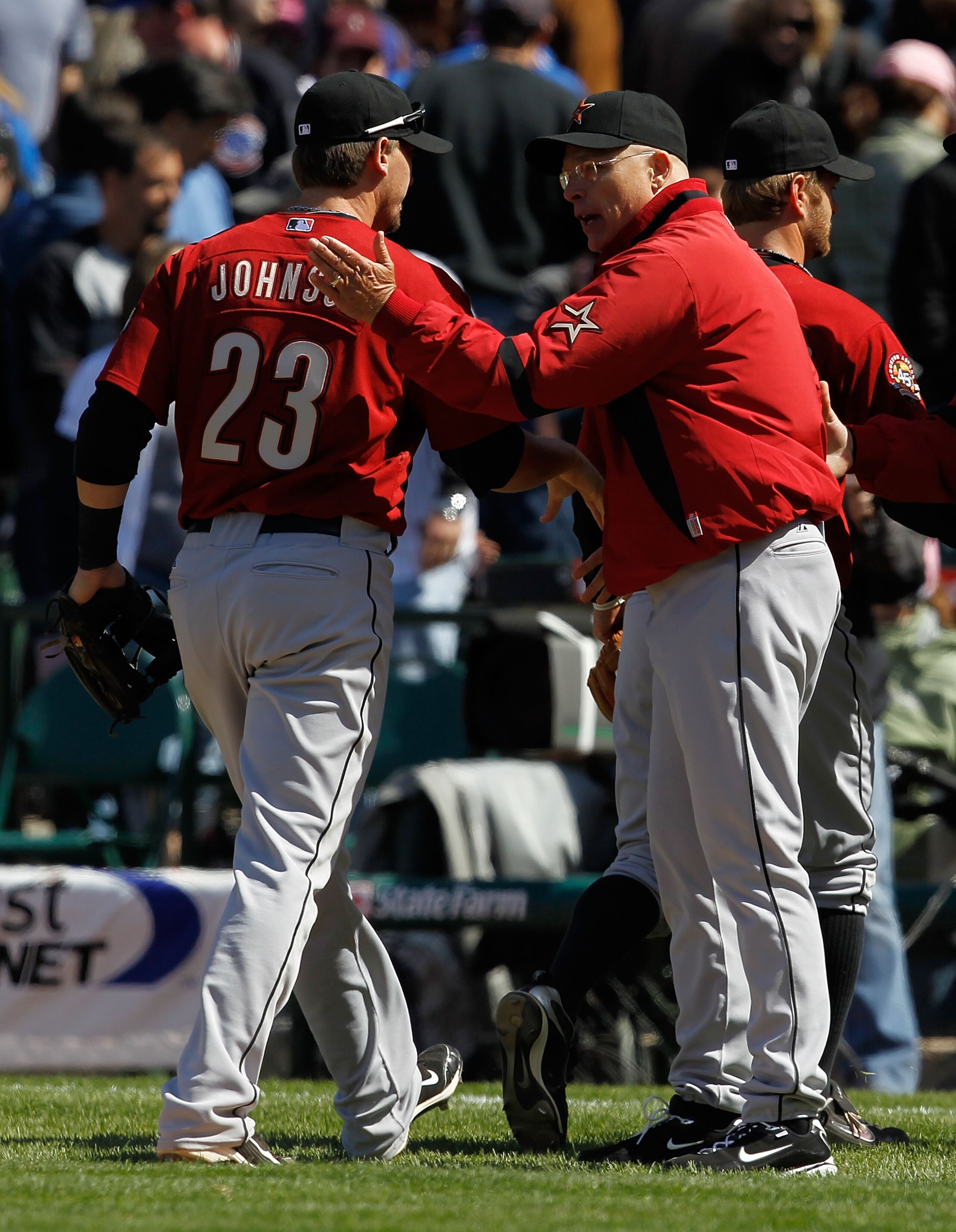CHICAGO - APRIL 17: Manager Brad Mills #2 of the Houston Astros congratulates Chris Johnson #23 after a win over the Chicago Cubs at Wrigley Field on April 17, 2010 in Chicago, Illinois. The Astros defeated the Cubs 4-3. (Photo by Jonathan Daniel/Getty Im