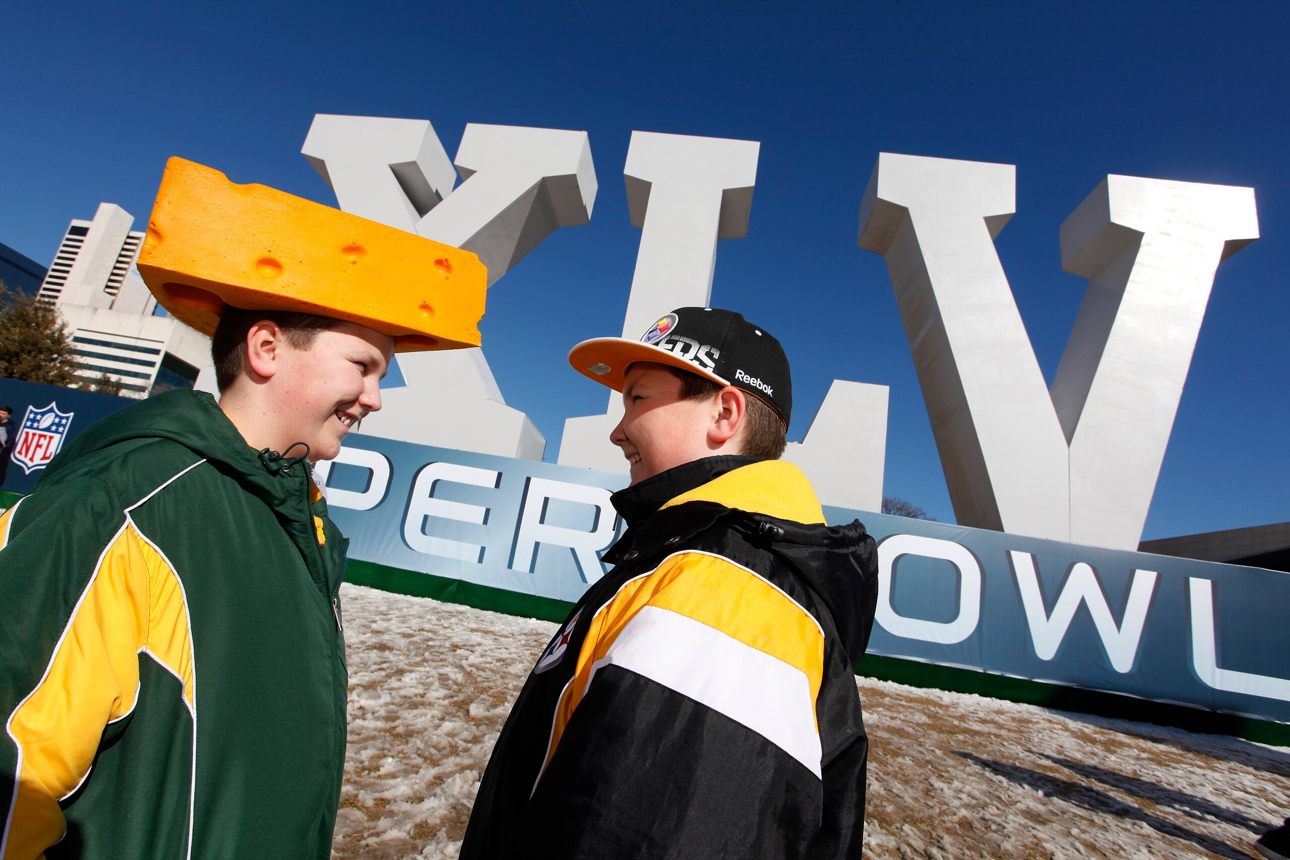 DALLAS, TX - FEBRUARY 5:  Twin brothers Michael (left) and Jon Mangless of Green Bay, Wisconsin wait outside before visiting the NFL Experience at the Dallas Convention Center on February 5, 2011 in Dallas, Texas. (Photo by Joe Robbins/Getty Images)