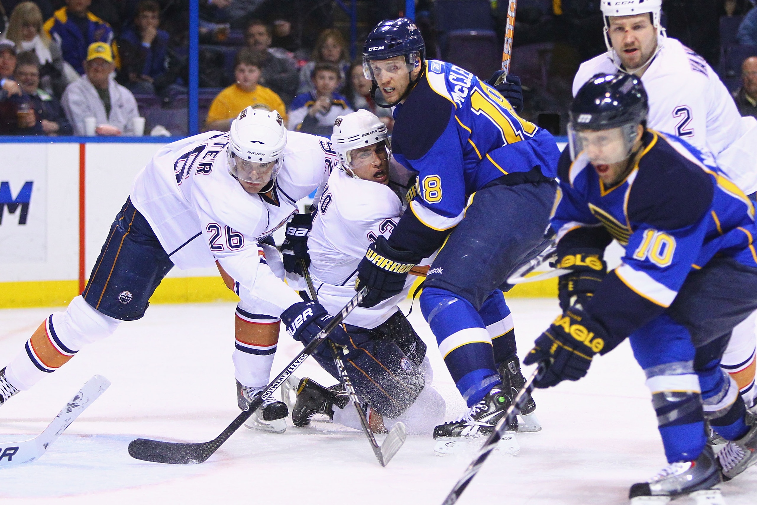 ST. LOUIS, MO - FEBRUARY 4: Jay McClement #18 of the St. Louis Blues looks for a pass against Kurtis Foster #26 and Andrew Cogliano #13 both of the Edmonton Oilers at the Scottrade Center on February 4, 2011 in St. Louis, Missouri.  (Photo by Dilip Vishwa