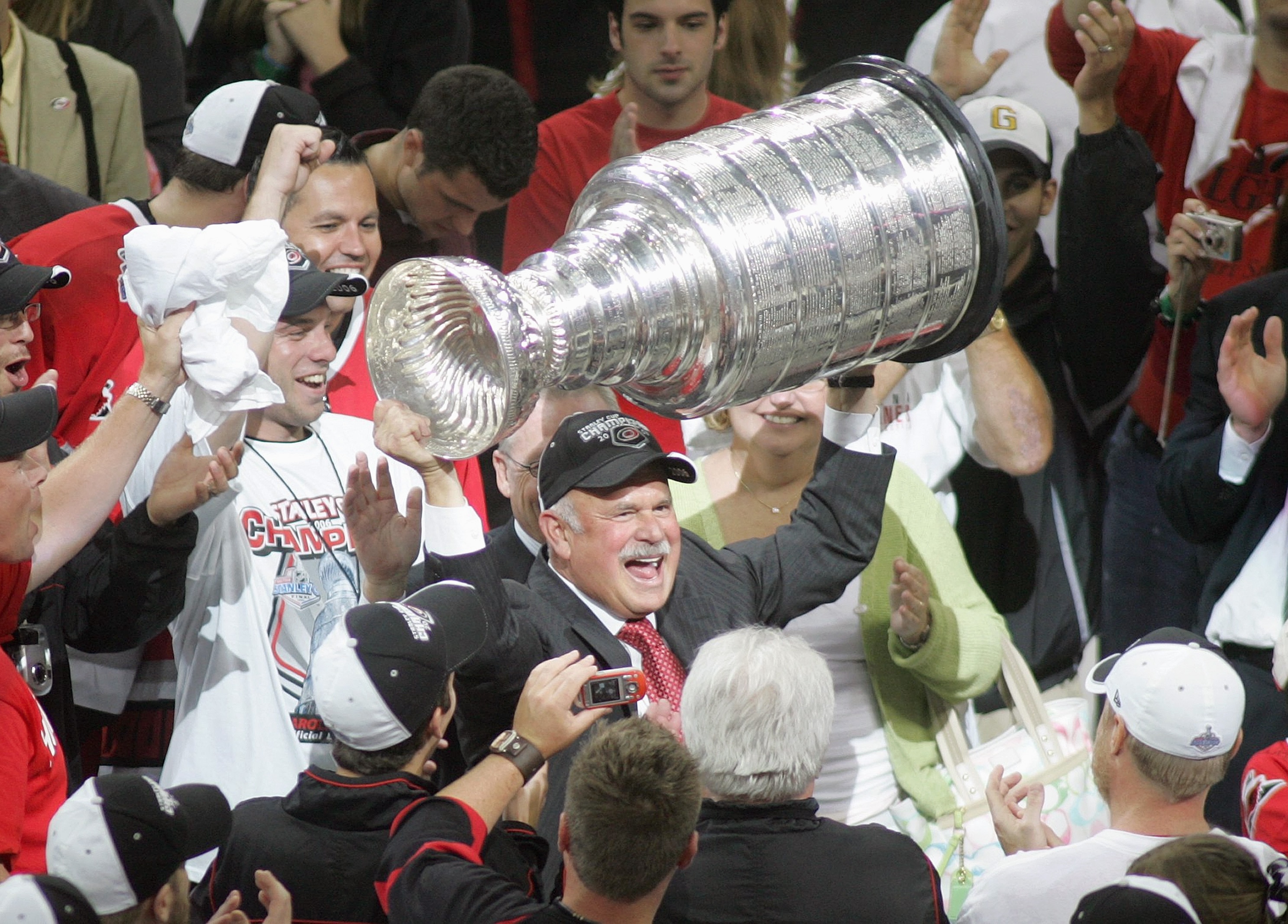 RALEIGH, NC - JUNE 19:  Chief Executive Officer of the Carolina Hurricanes Peter Karmanos Jr. hoists the Stanley Cup after game seven between the Hurricanes and the Edmonton Oilers of the 2006 NHL Stanley Cup Finals on June 19, 2006 at the RBC Center in R