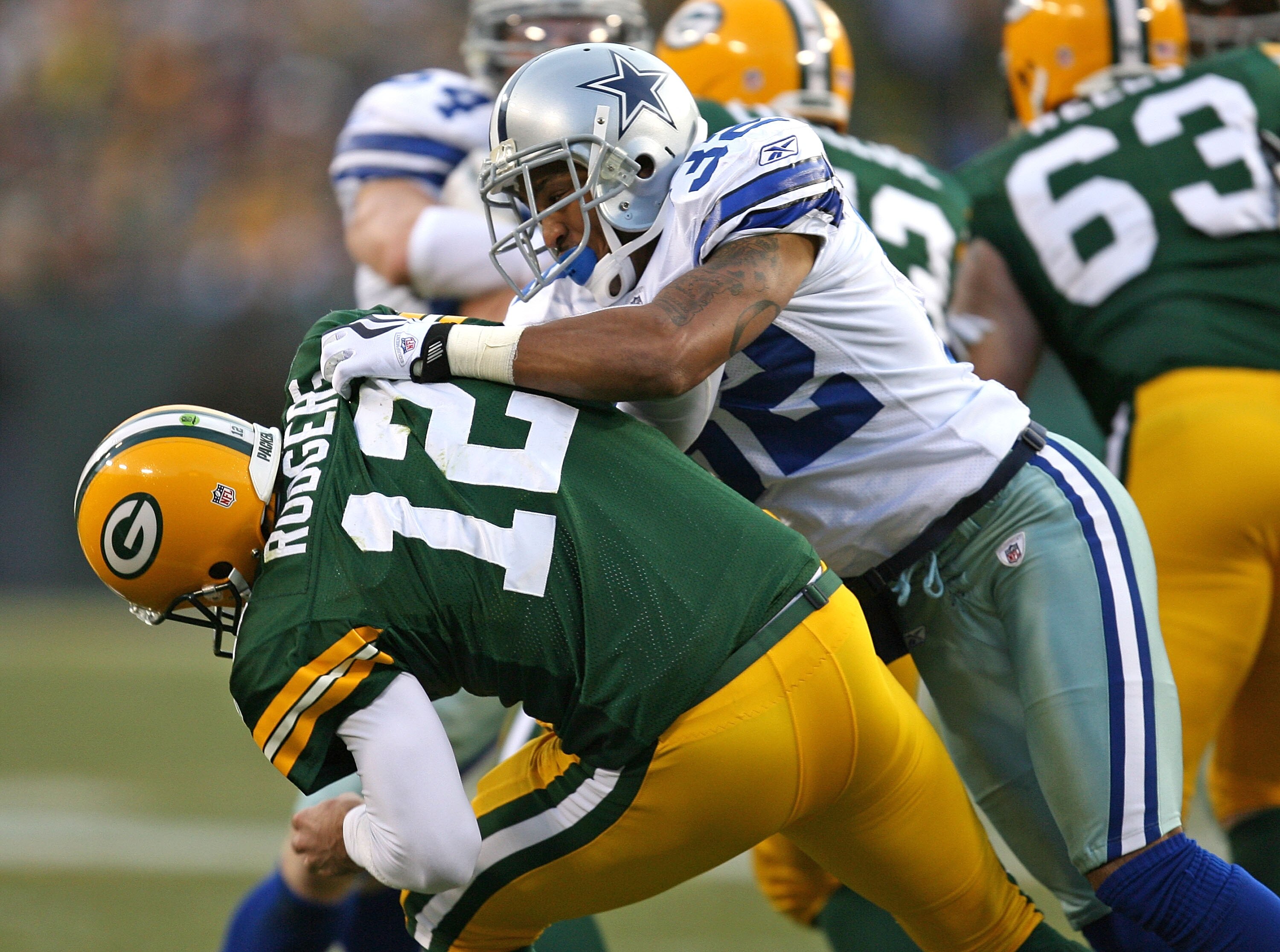 GREEN BAY, WI - NOVEMBER 15: Aaron Rodgers #12 of the Green Bay Packers is hit by Orlando Scandrick #32 of the Dallas Cowboys on a blitz at Lambeau Field on November 15, 2009 in Green Bay, Wisconsin.  (Photo by Jonathan Daniel/Getty Images)