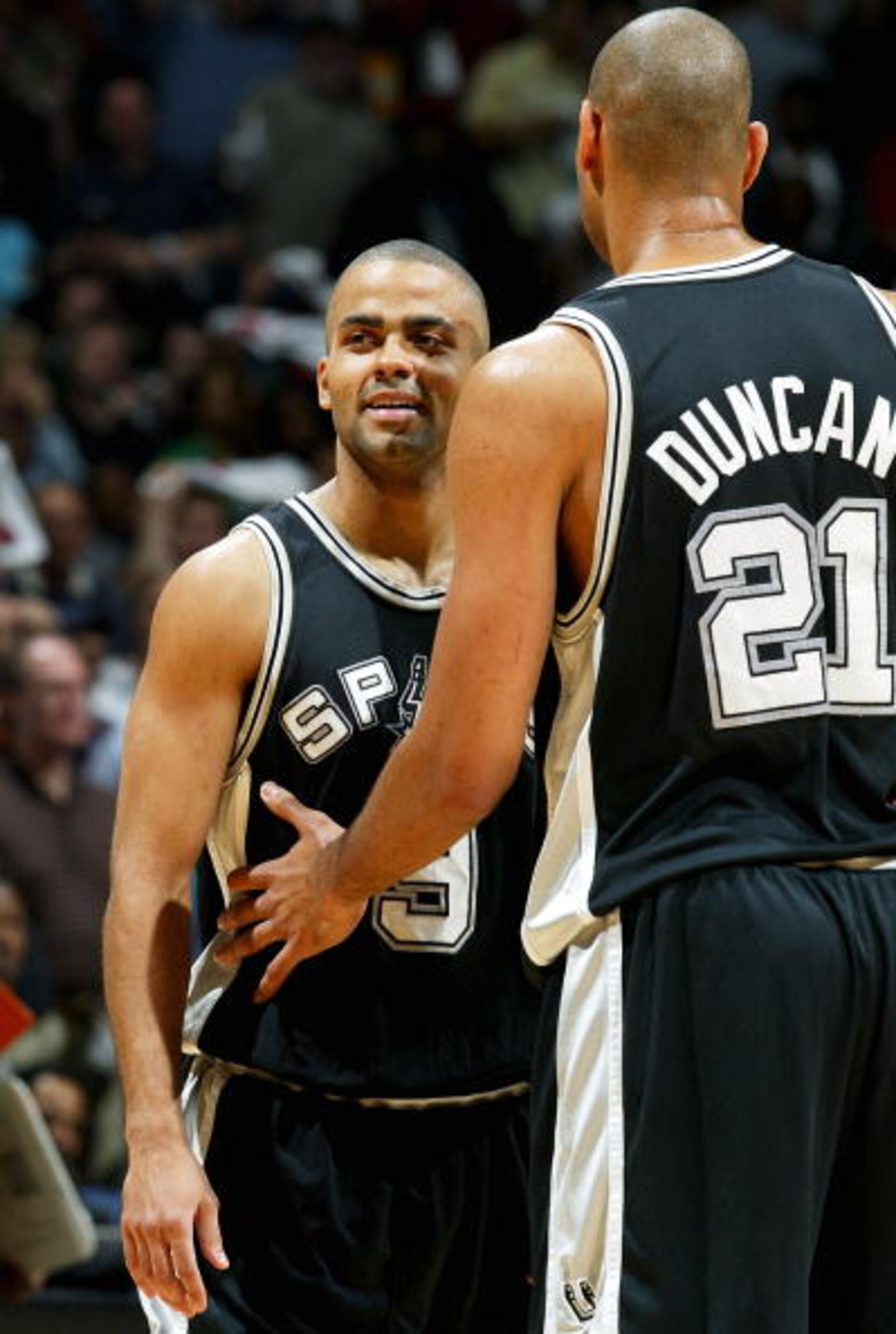 MEMPHIS, TN - APRIL 25:  Tony Parker #9 of the San Antonio Spurs is restrained by teammate Tim Duncan #21 after being hit hard going to the basket against the Memphis Grizzlies during Game four of Western Conference Quarterfinals of the 2004 NBA Playoffs