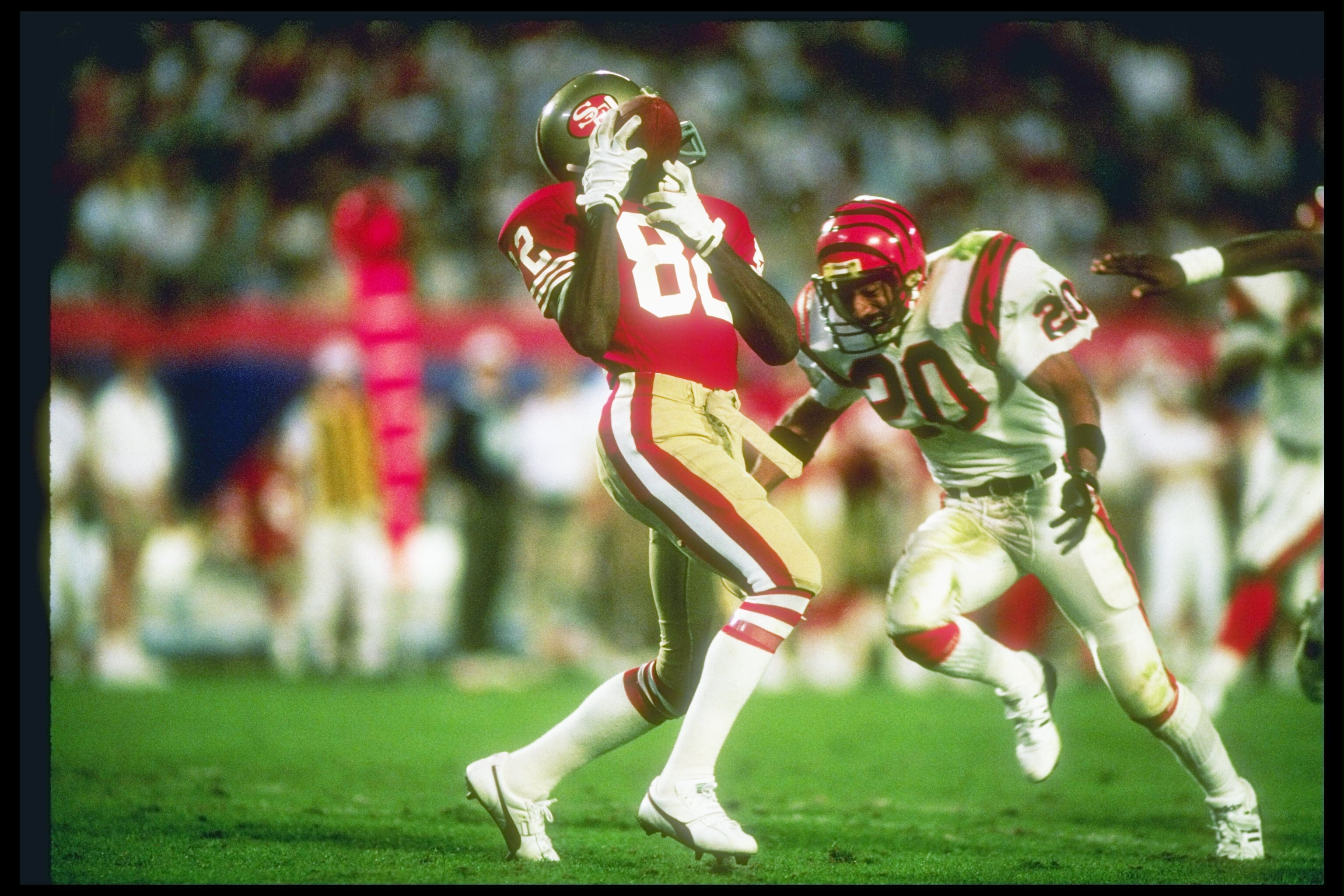22 Jan 1989:  Wide receiver John Taylor #82 of the San Francisco 49ers makes a catch as defensive back Ray Horton #20 of the Cincinnati Bengals moves in during Super Bowl XXIII at the Joe Robbie Stadium in Miami, Florida.  The 49ers won the game 20-16.