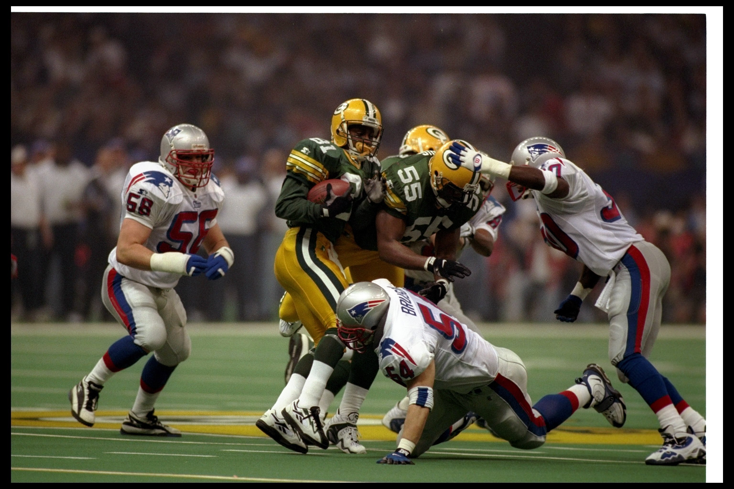 26 Jan 1997:  Wide receiver Desmond Howard of the Green Bay Packers gets tackled during Super Bowl XXXI against the New England Patriots at the Superdome in New Orleans, Louisiana.  The Packers won the game, 35-21. Mandatory Credit: Al Bello  /Allsport